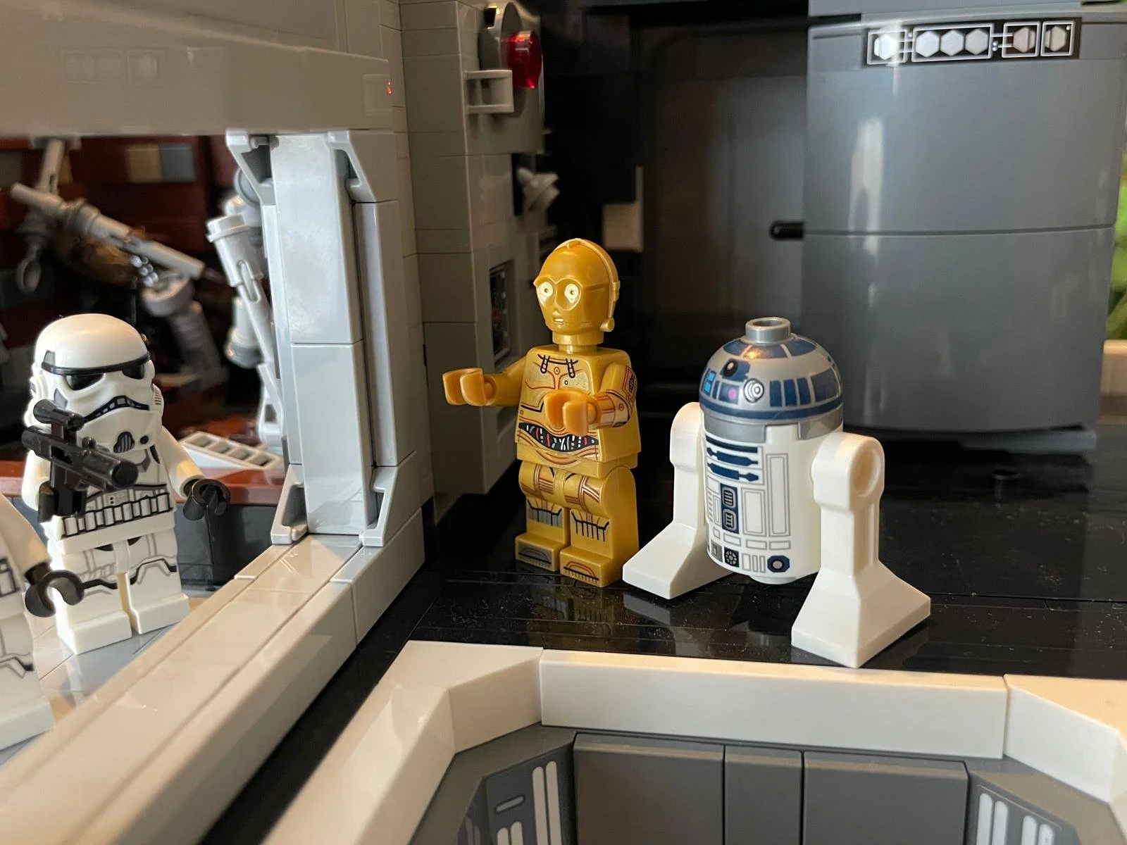 LEGO Star Wars figures including a stormtrooper, R2-D2, and C-3PO in a LEGO spaceship interior.