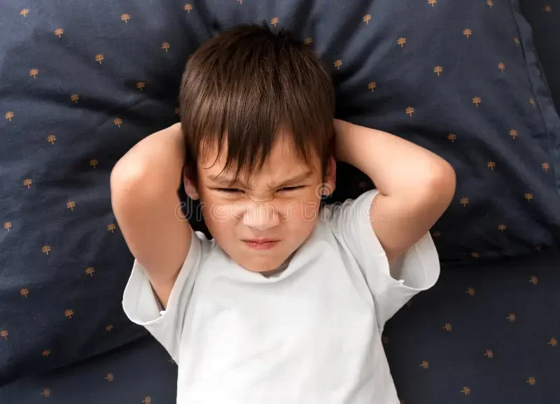 cranky-child-boy-refuses-to-go-to-bed-cranky-child-boy-refuses-to-go-to-bed-toddler-boy-laying-bed-arms-under-head-119102026.webp