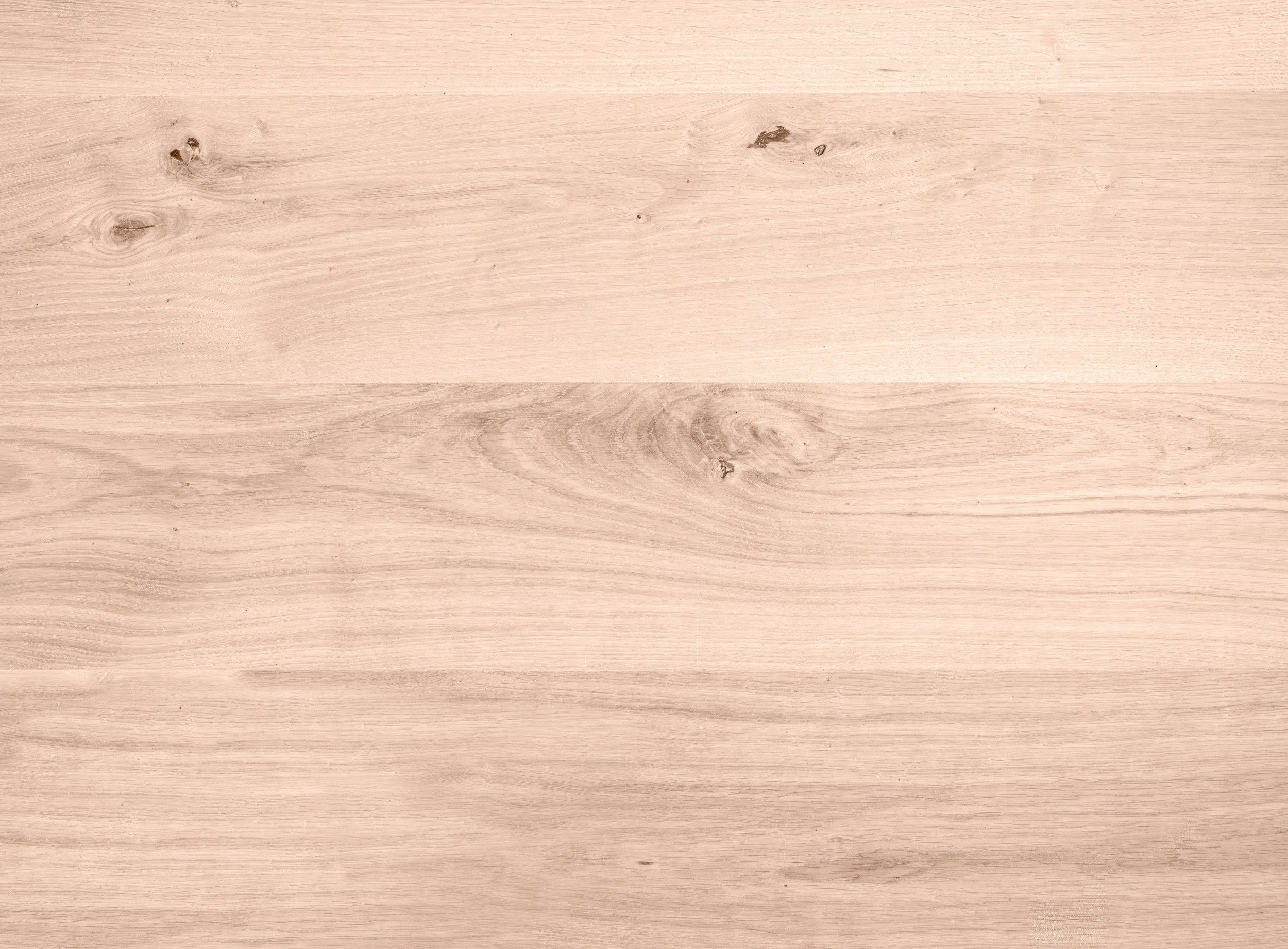 Light-colored wooden surface with visible wood grain and knots.