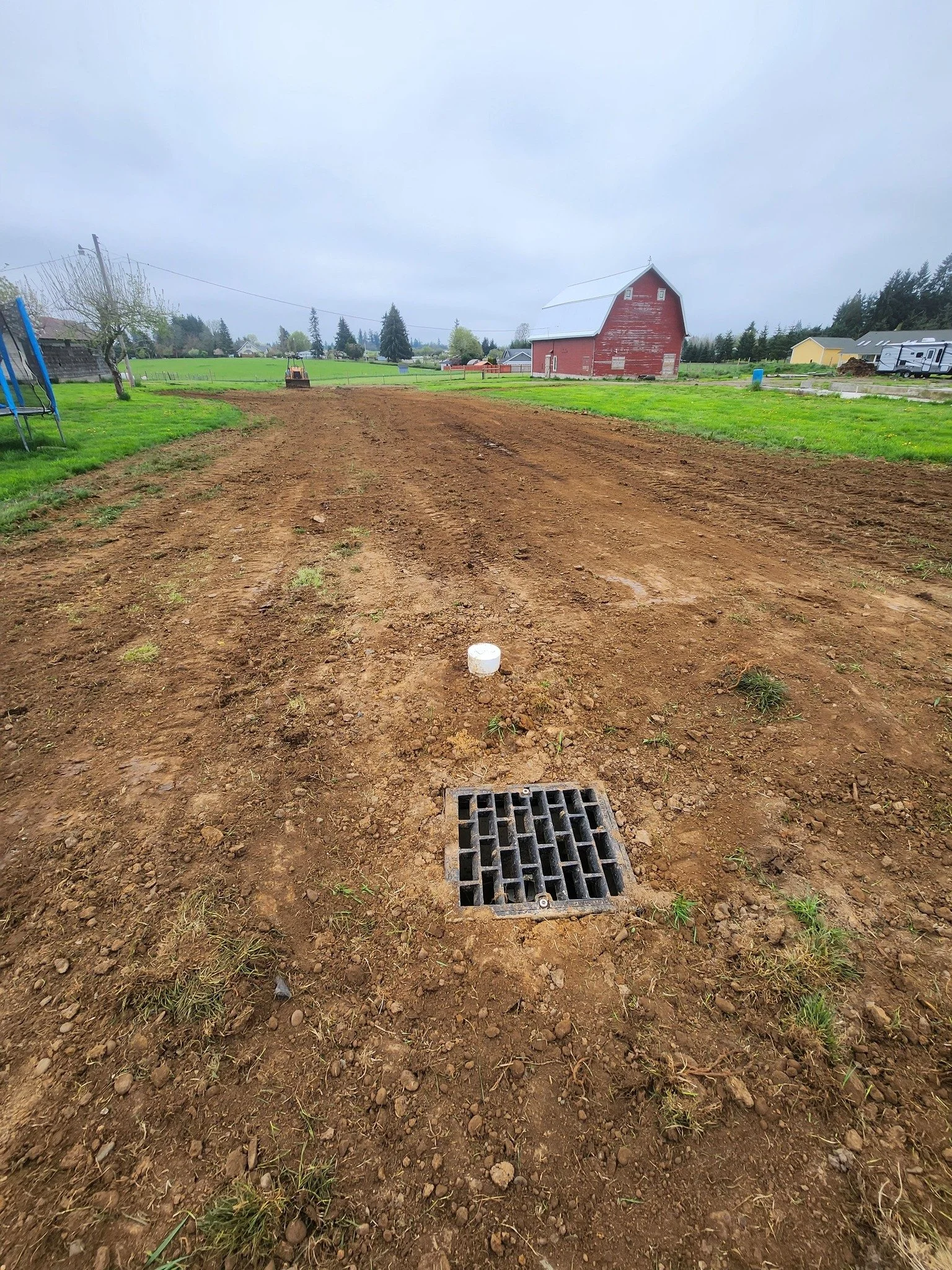 Catch Basin and French drain installed to collect and drain water for a dry yard in Winlock WA