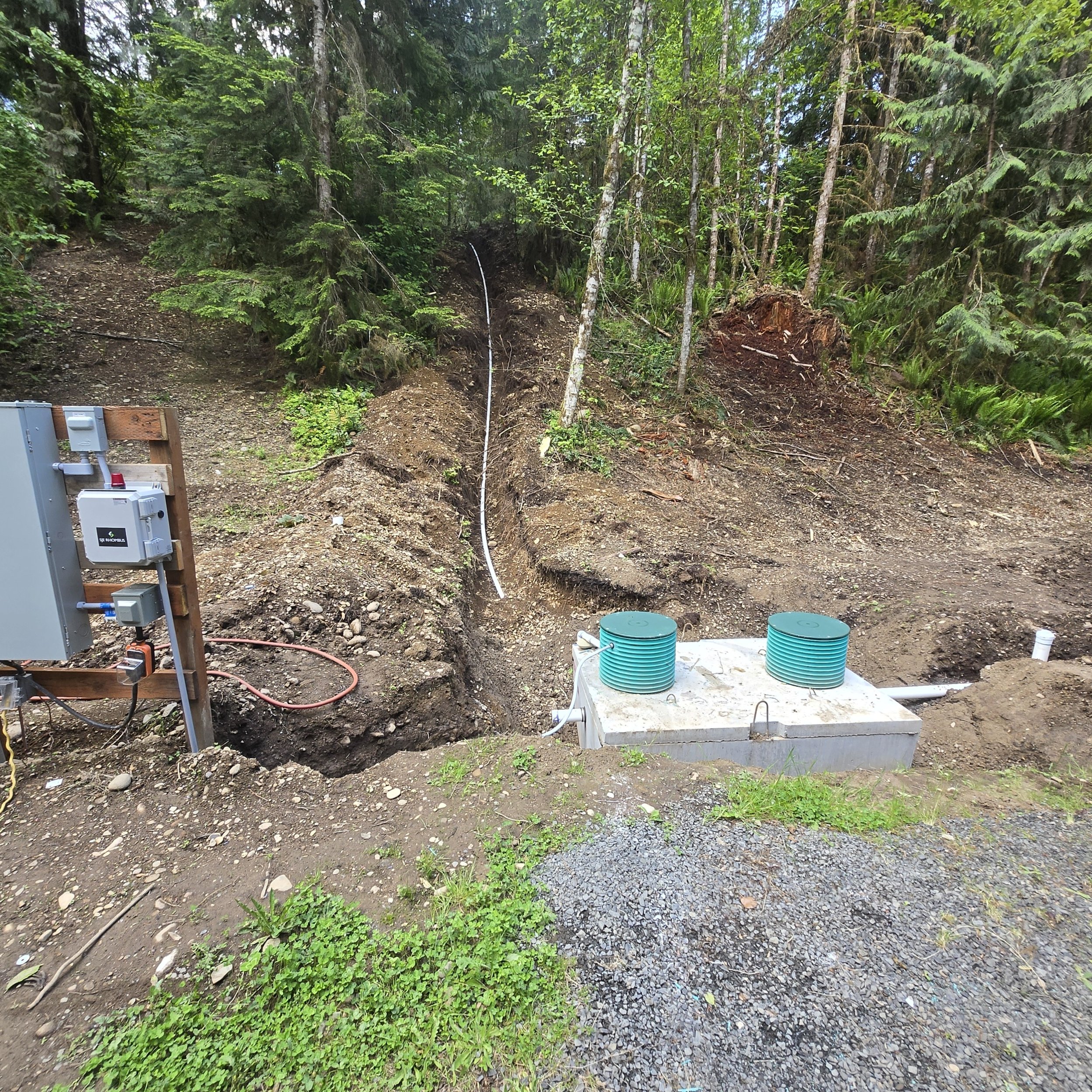 Tank being set by excavator: septic tank installation Lewis County WA
