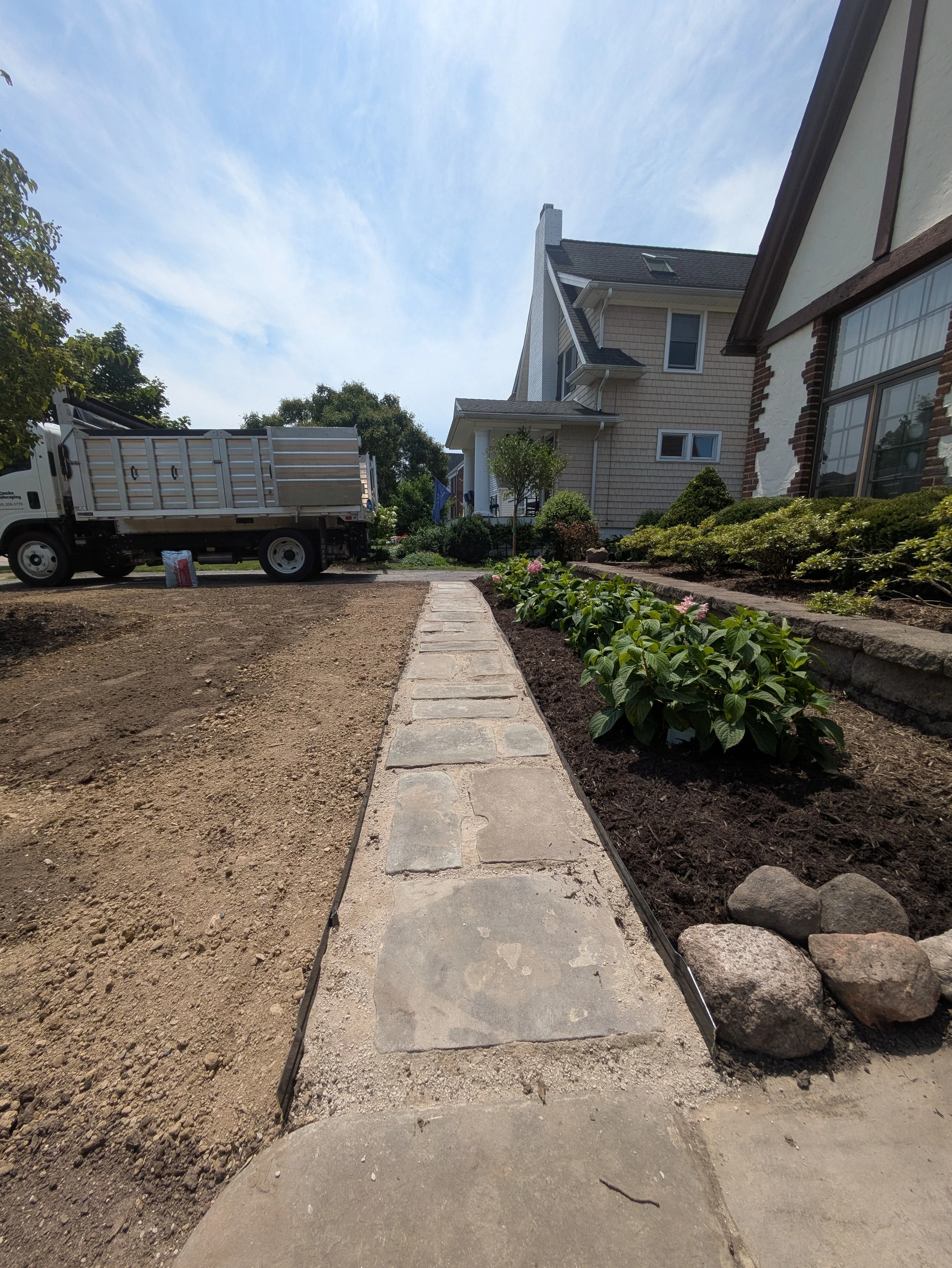 New planting and paver walkway installation