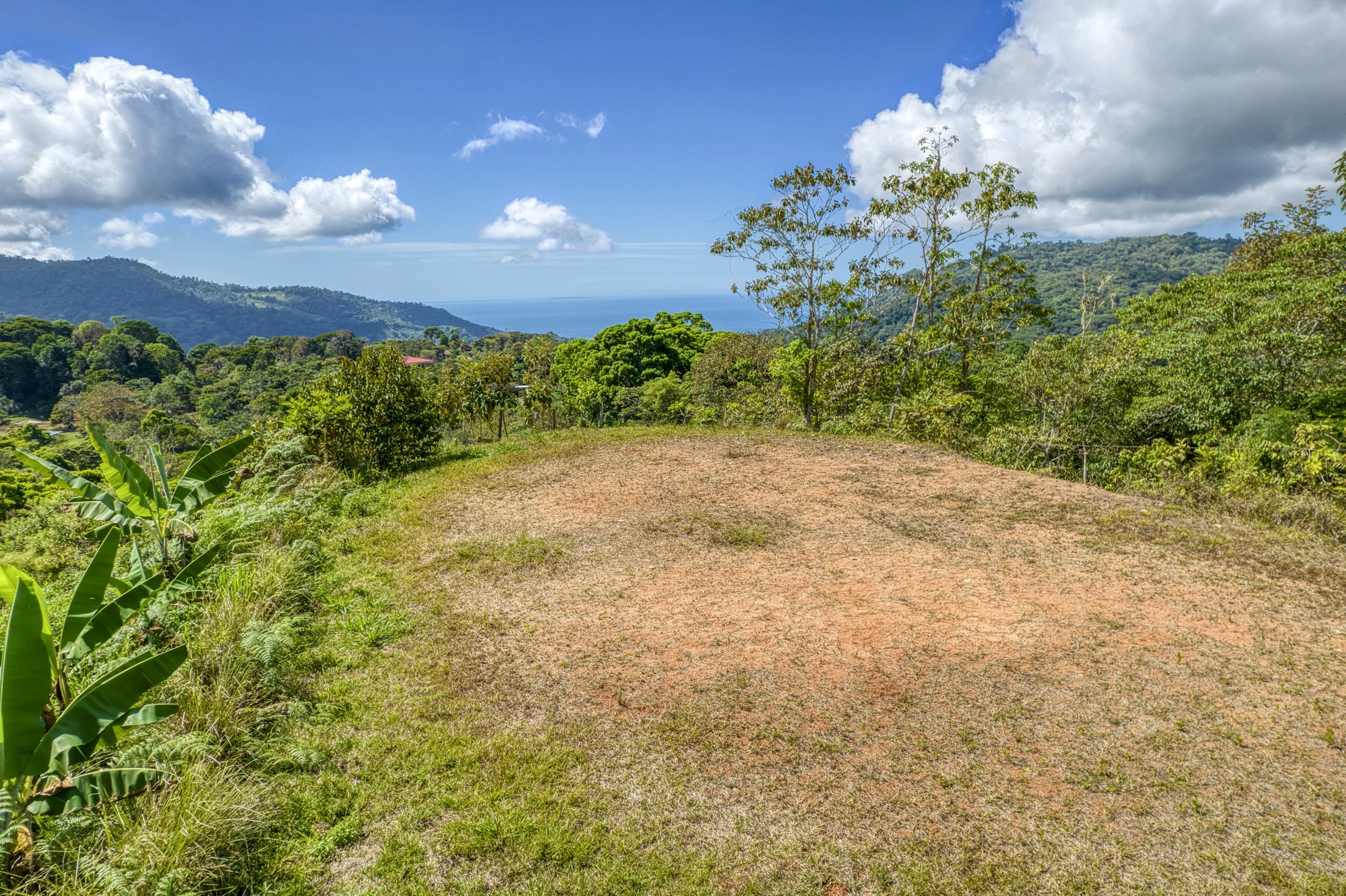 Cleared, build-ready plantel with mountain and partial ocean views near Uvita