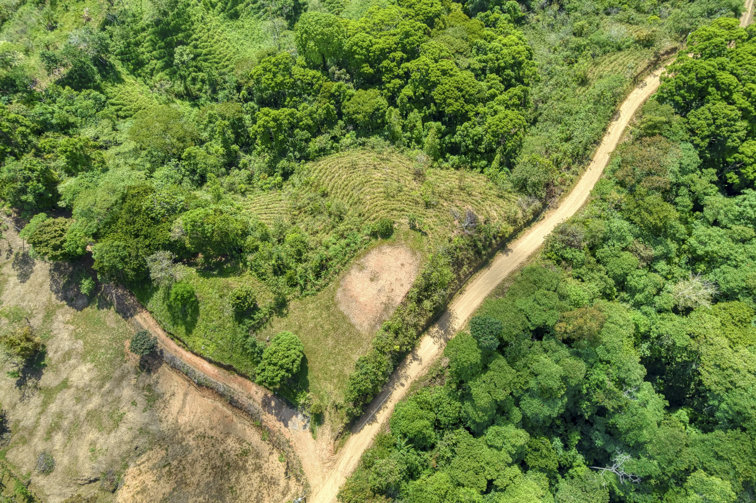 Drone view of primary build site, terrain and access roads on Costa Rica acreage