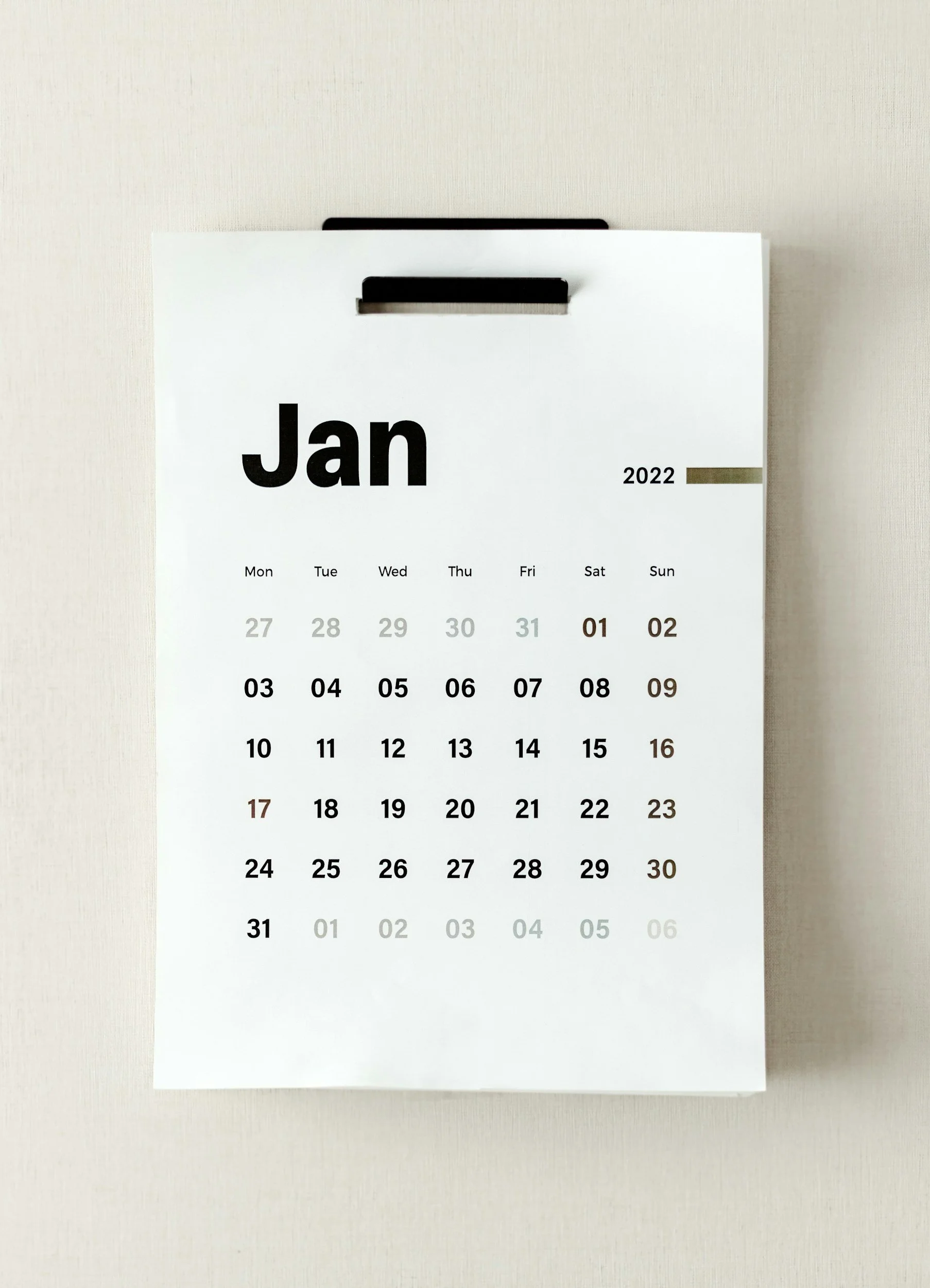 Calendar page for January 2022 hanging on a wall.