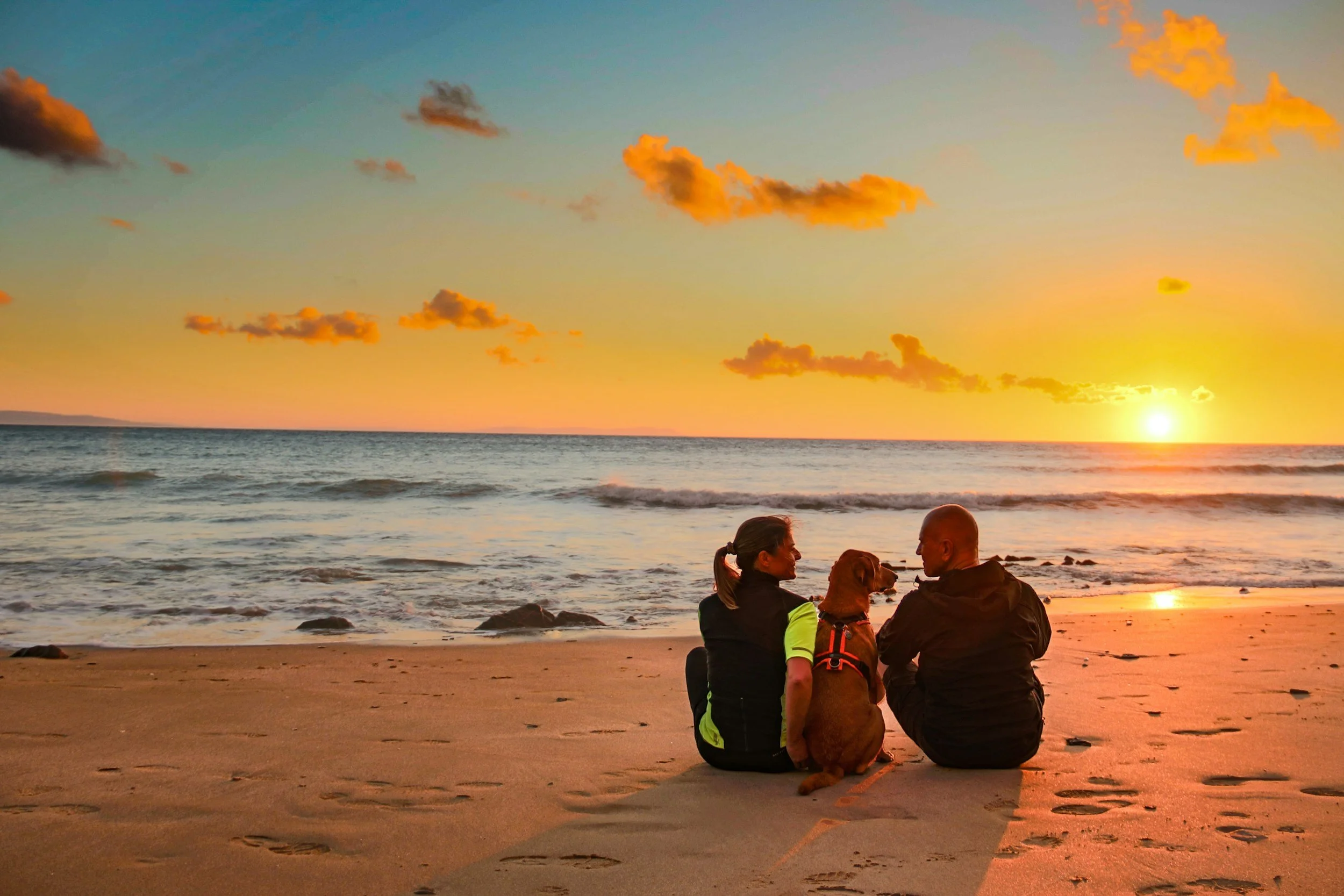 Couple enjoying Marbella beach, representing expats with private health insurance in Marbella, Spain