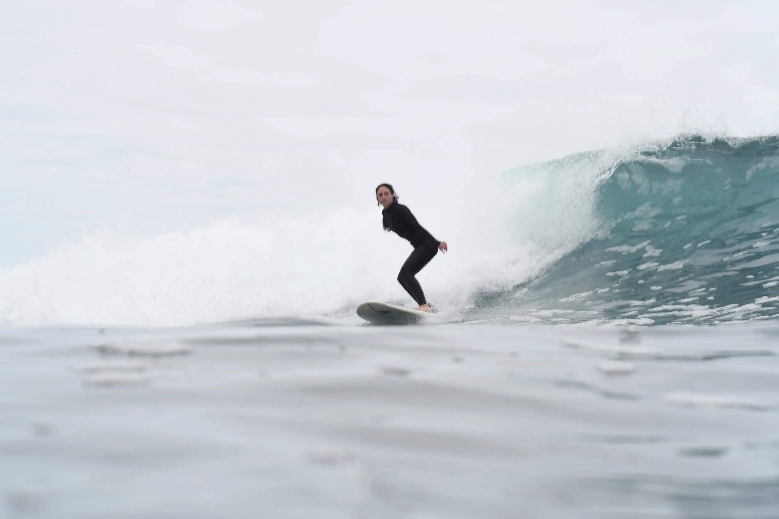 Angie surfing. Surfing fosters confidence and mindfulness.