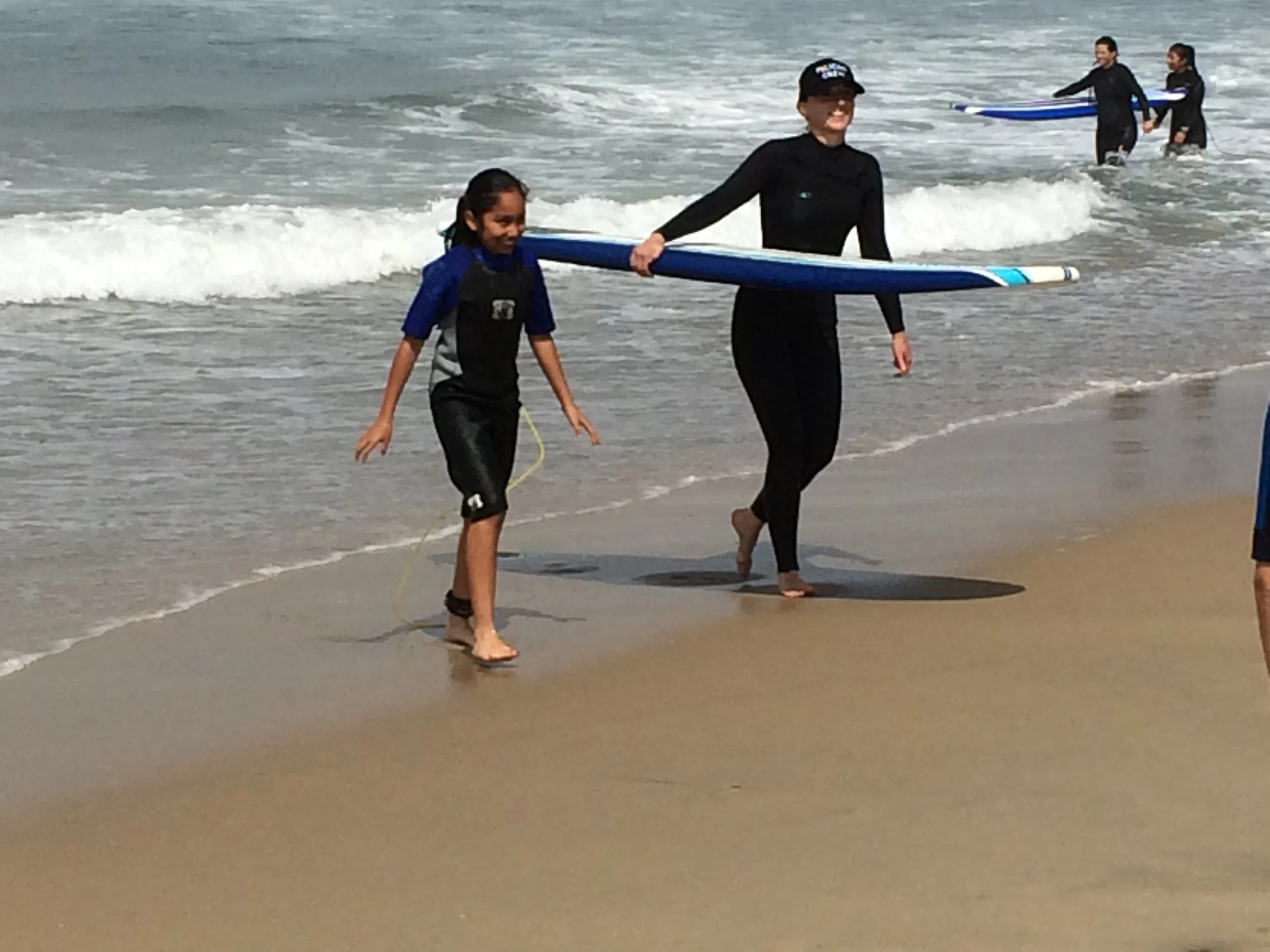Angie giving surf lessons to the kids in Operation Progress.