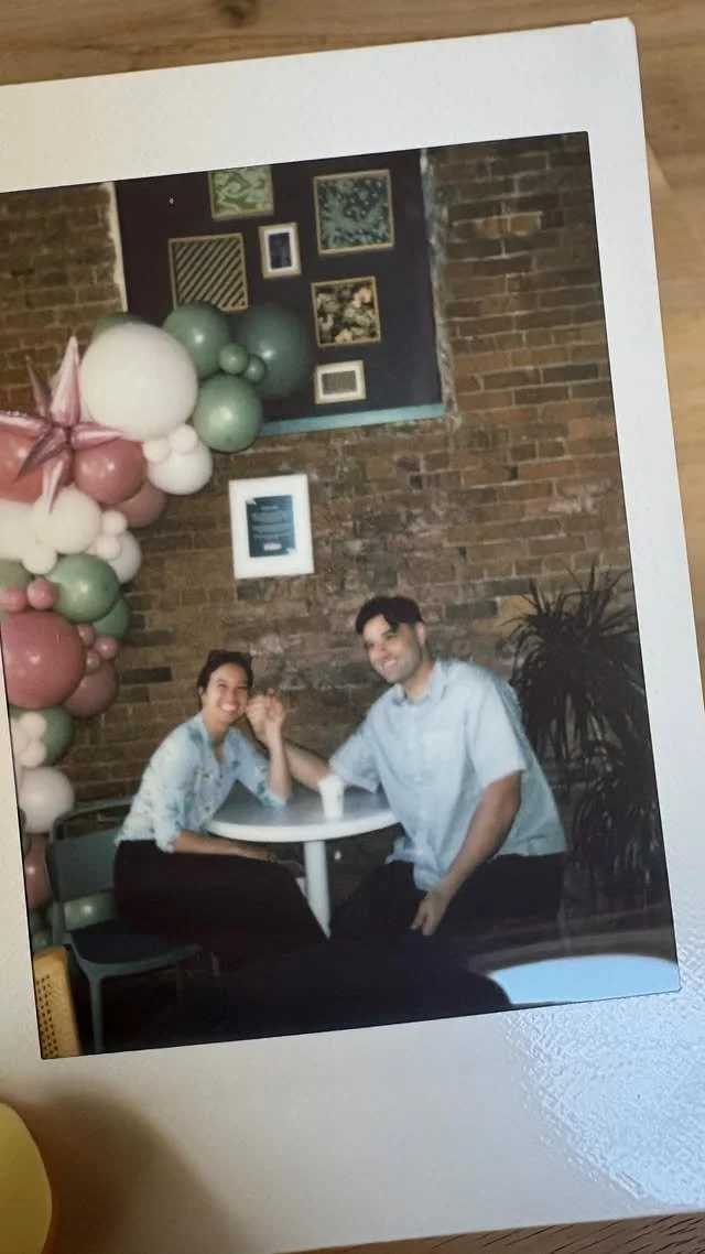 Wairua owners Hanisa & Wilson sitting at a table during the one-year aniversary celebration