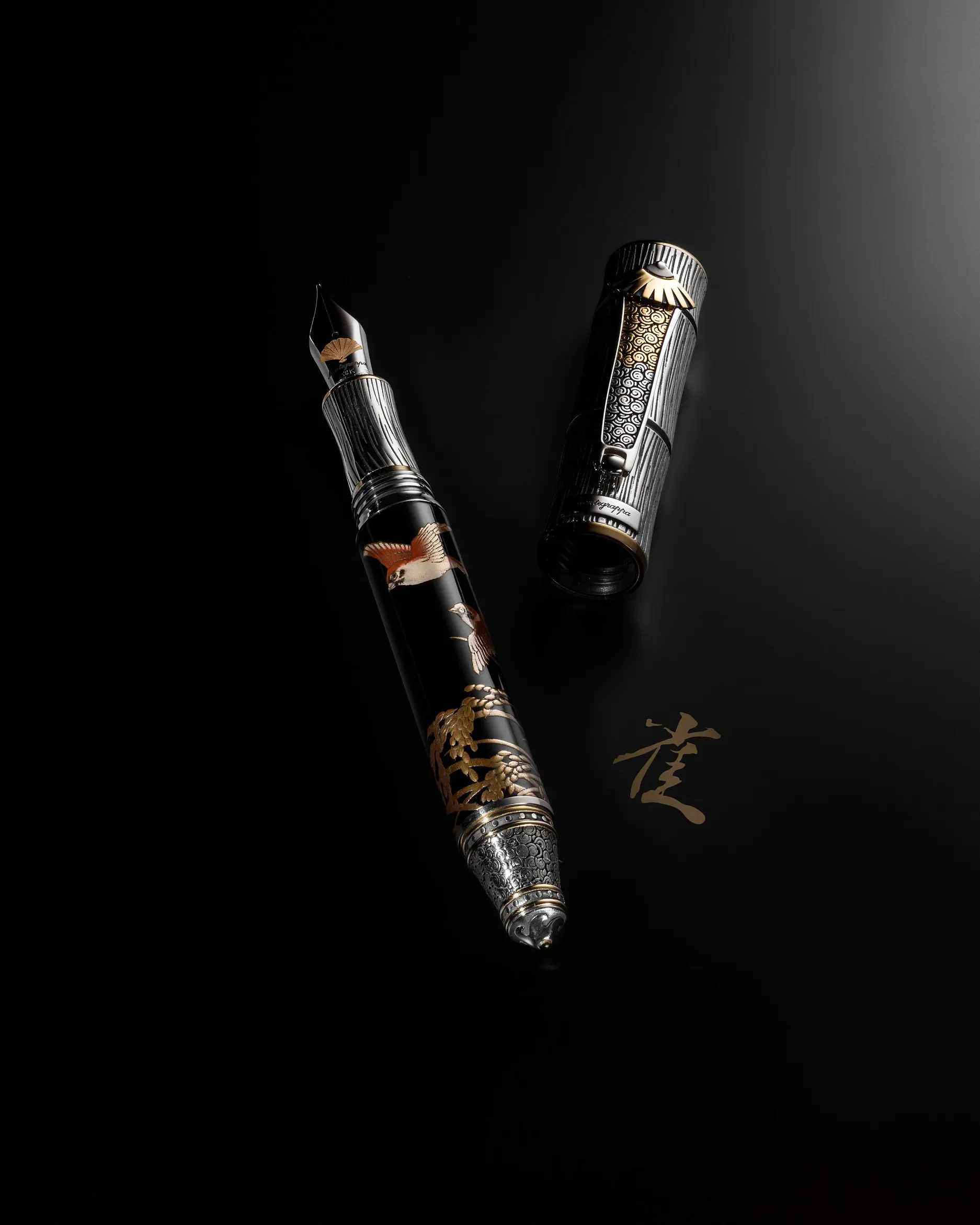 Luxury fountain pen with intricate black and gold design, featuring a bird motif, placed on a black surface with a gold Chinese character