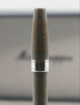 A close-up of a smoking vape pen with a cloudy background.
