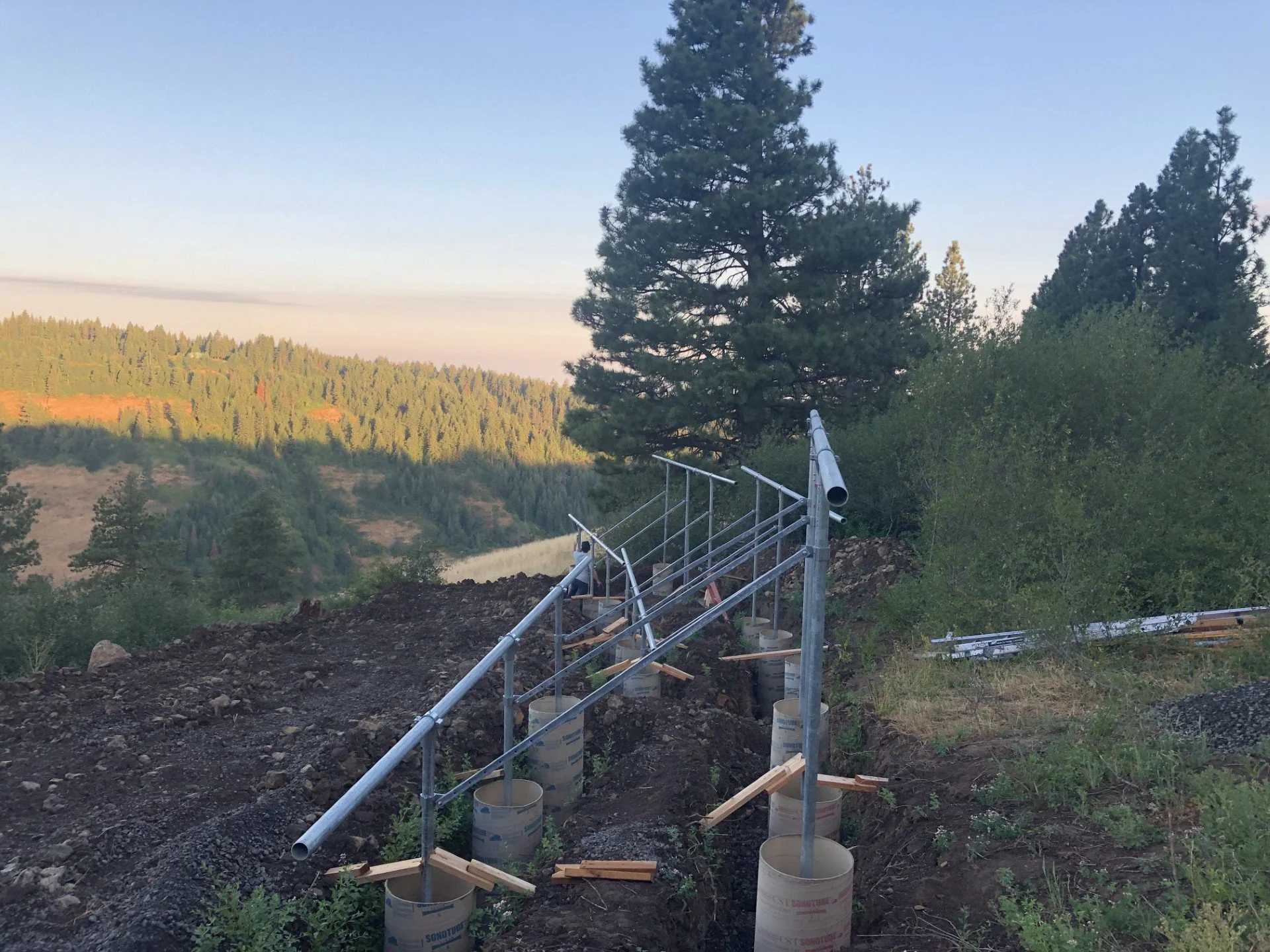 Ground mount foundation work for solar panels supporting a remote off grid home.