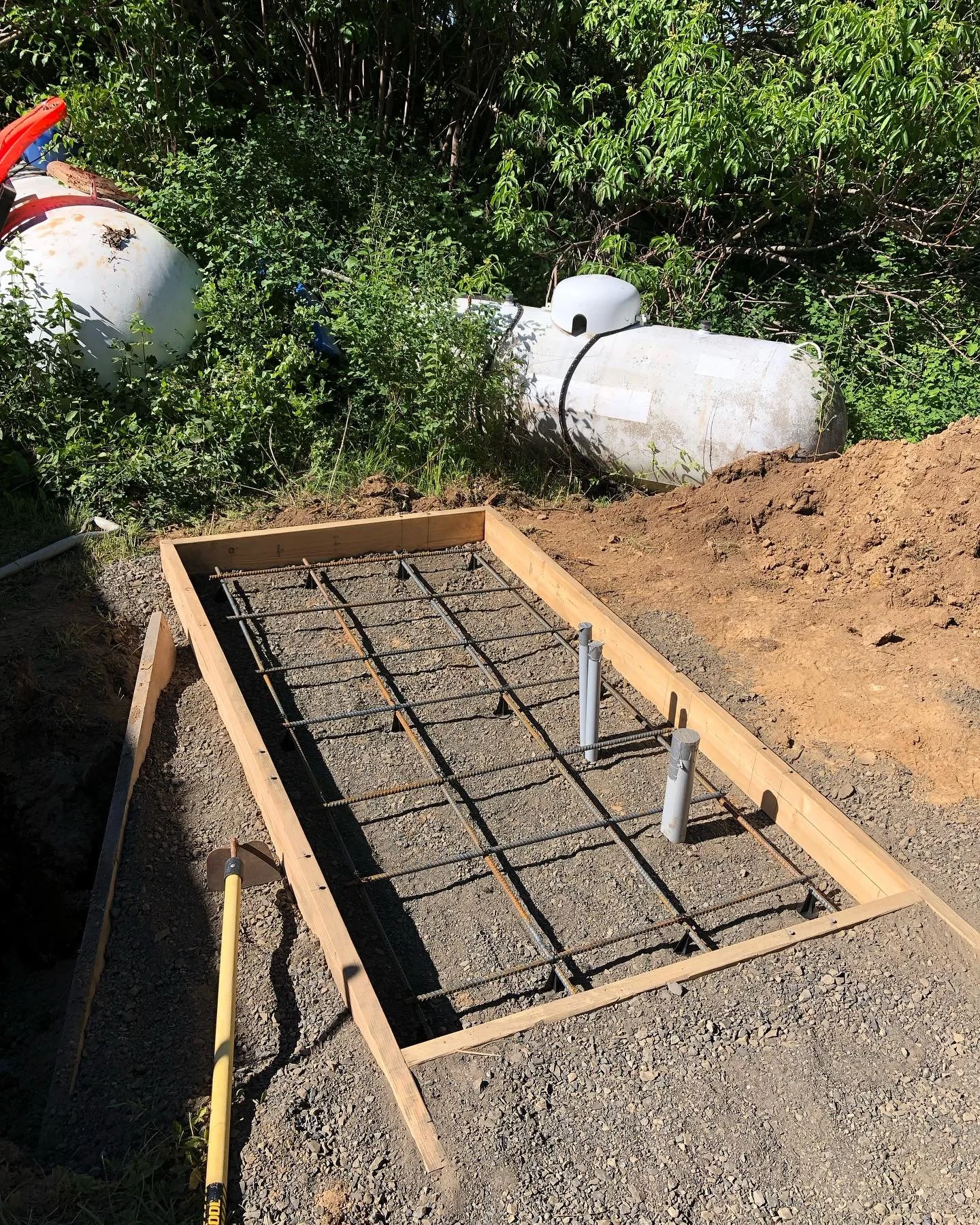 Form work and rebar for a concrete pad with integrated conduit for a large generator.