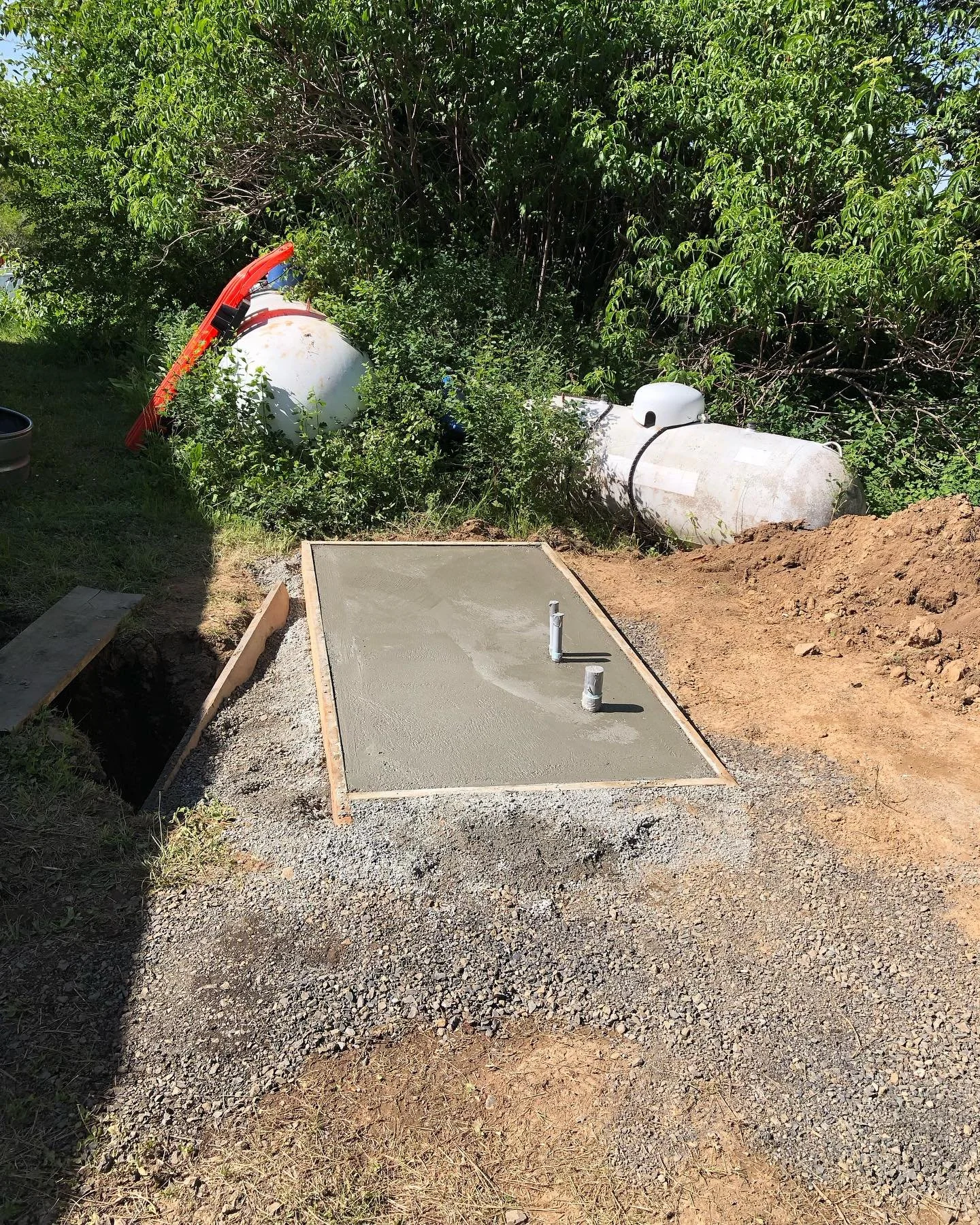 Freshly poured concrete foundation with conduit for a large generator.