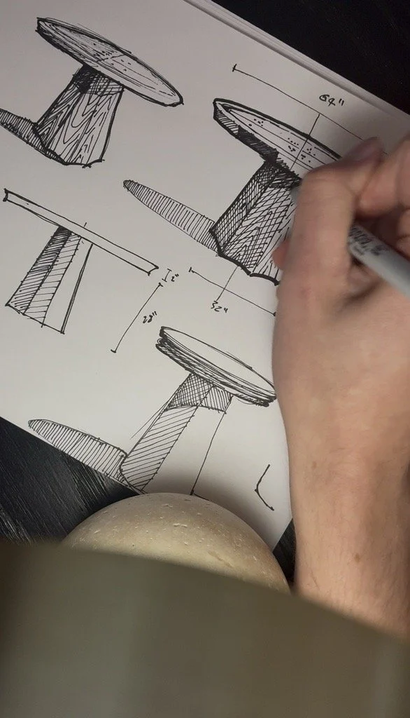 Sketches of wooden Dining Table with measurements and a hand drawing on a sheet of paper.