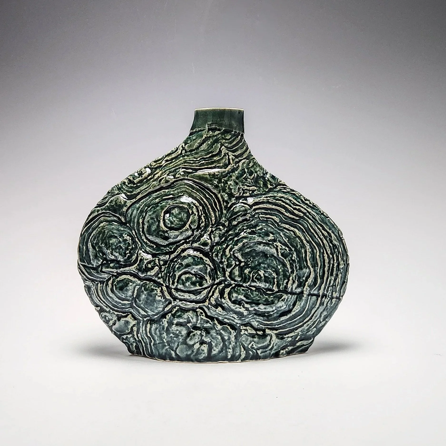 Stromatolite Vase. Texture captured from stromatolite fossils in the Petrified Sea Gardens, Saratoga Springs, NY. Cone 6, oxidation. 2025.