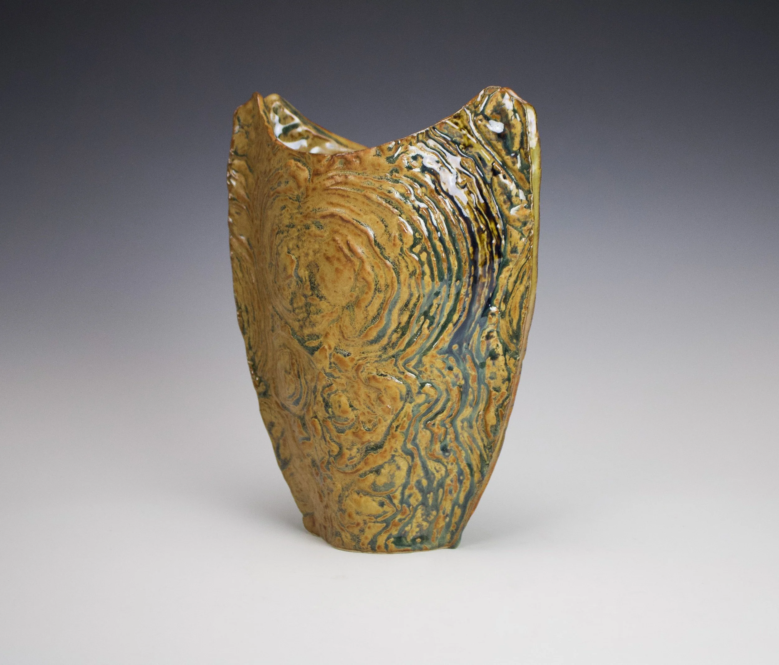 Stromatolite Vase 2. Texture captured from stromatolite fossils in the Petrified Sea Gardens, Saratoga Springs, NY. Cone 10 reduction, 2025.