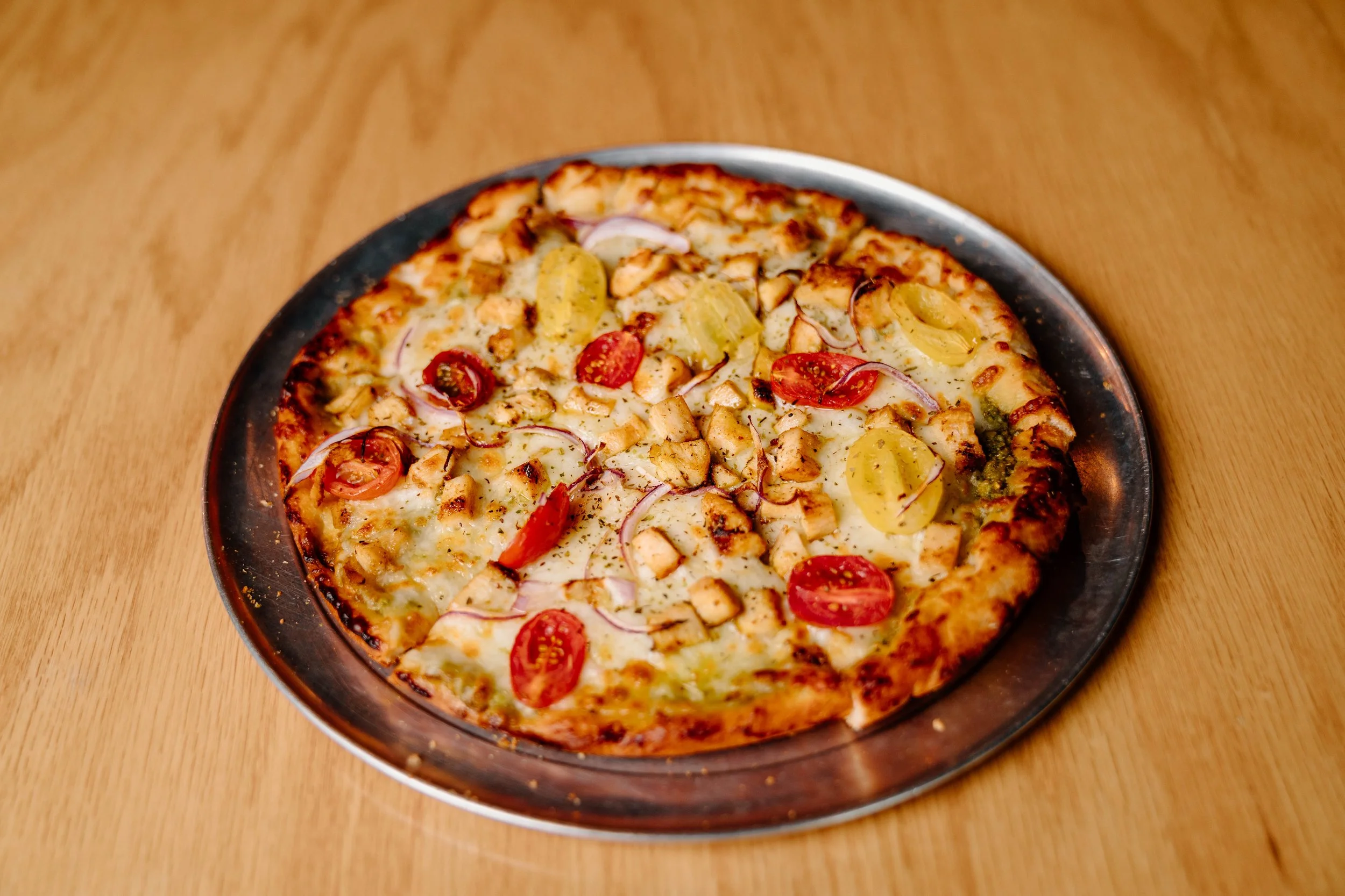 Pesto chicken pizza with tomatoes