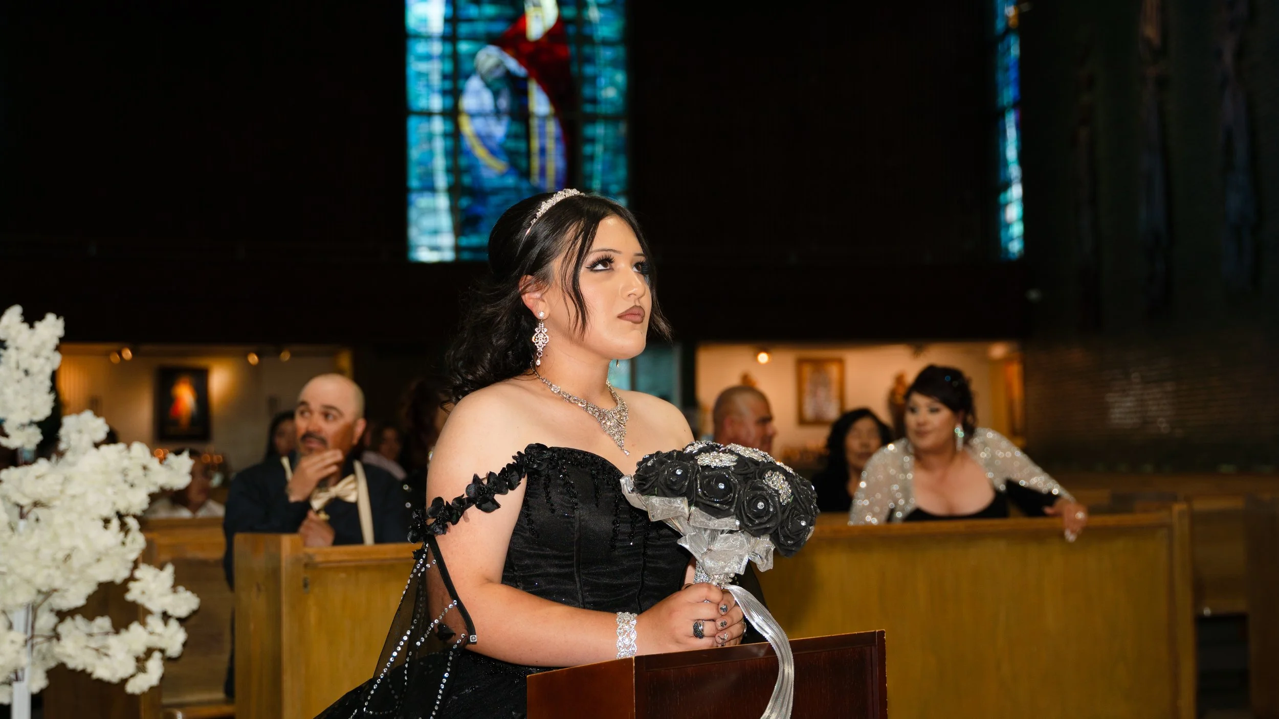 Laurie’s customers, Mariana and Carmen holding hands on a green lawn on their wedding day.