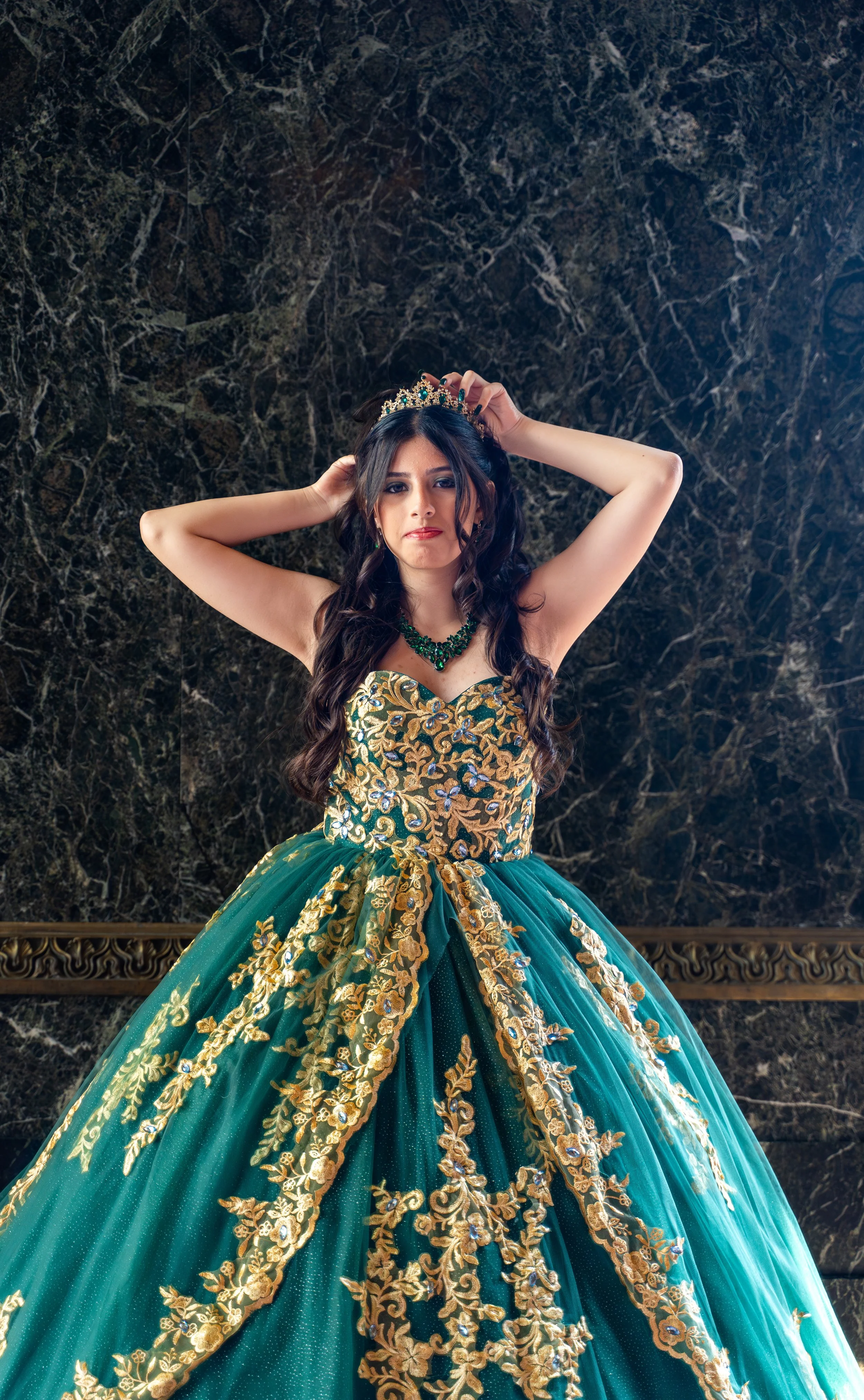 Laurie’s customers, Mariana and Carmen holding hands on a green lawn on their wedding day.