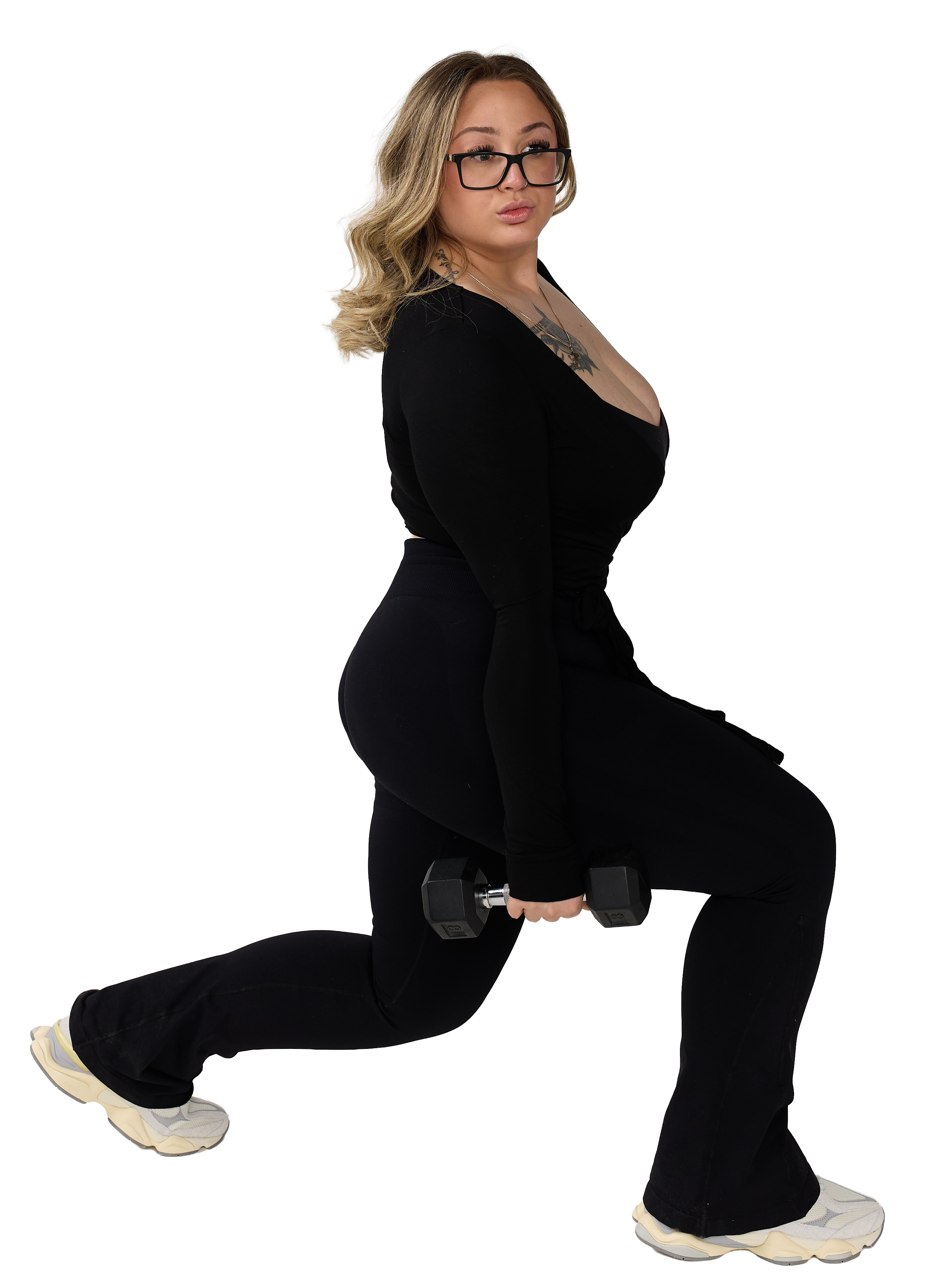 Vic in black workout attire performing lunges with dumbbells.