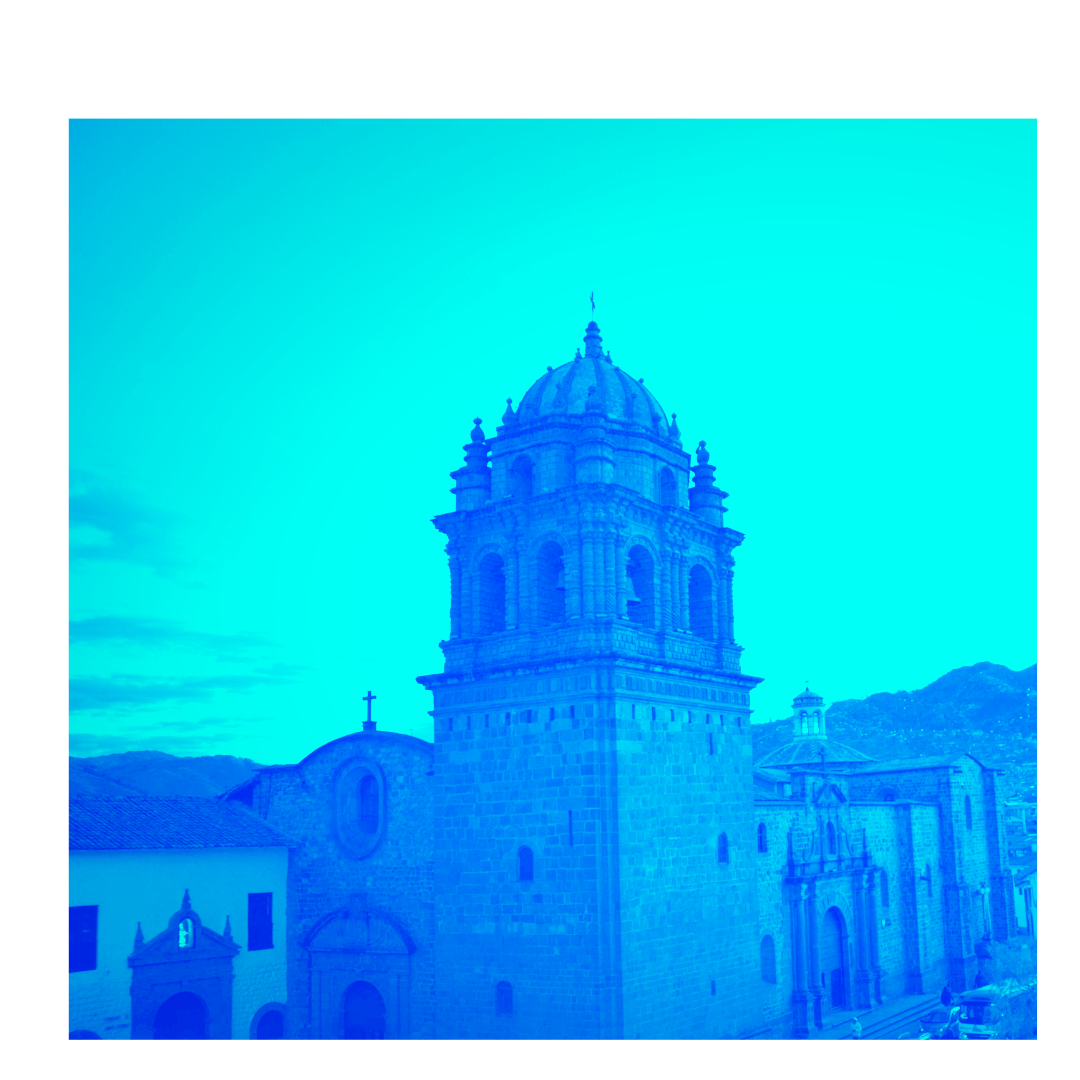 A historic church with a prominent bell tower and domed roof, situated in a mountainous area.
