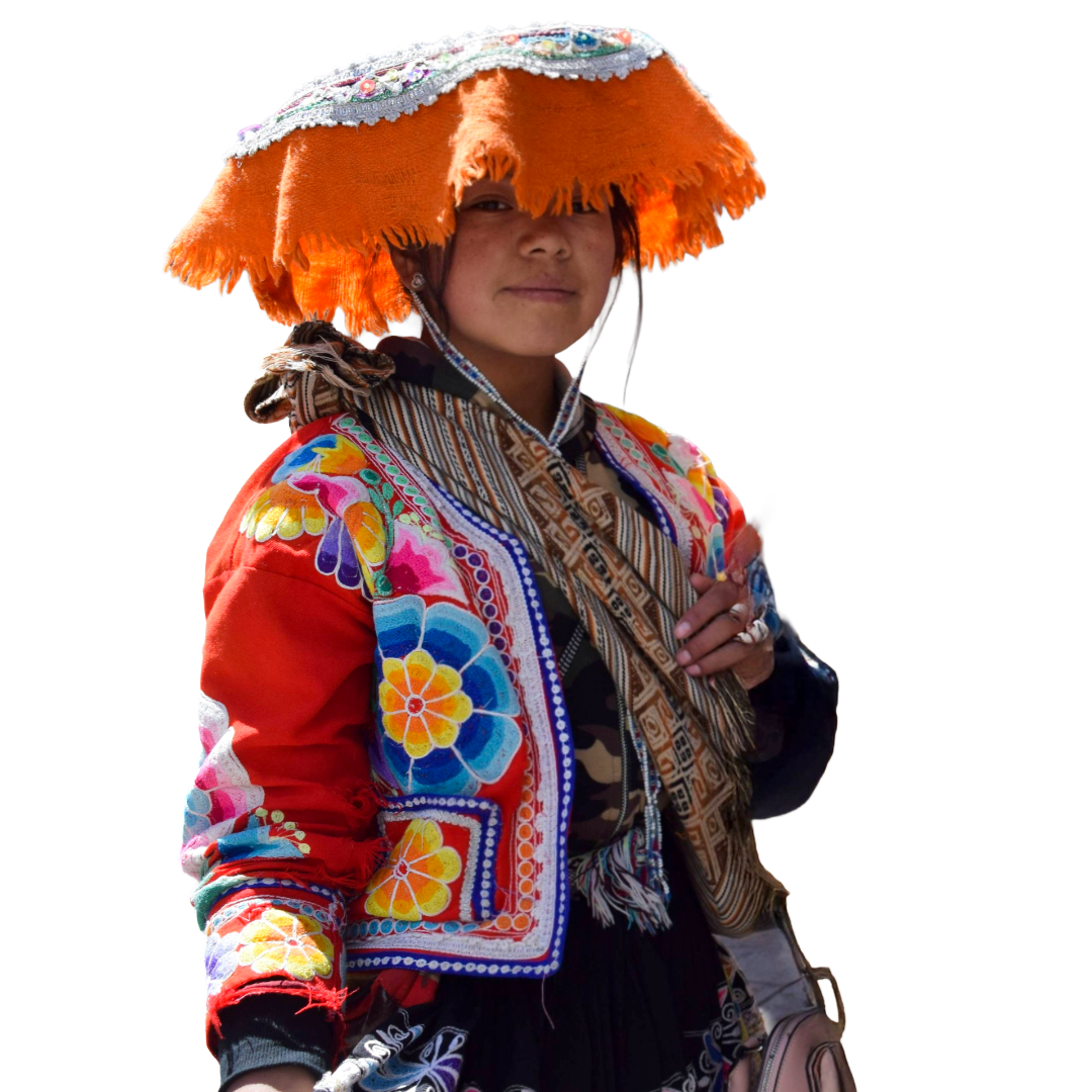 A woman wearing colorful, traditional embroidered clothing and a large, decorative orange hat with shiny embellishments, standing against a white background.