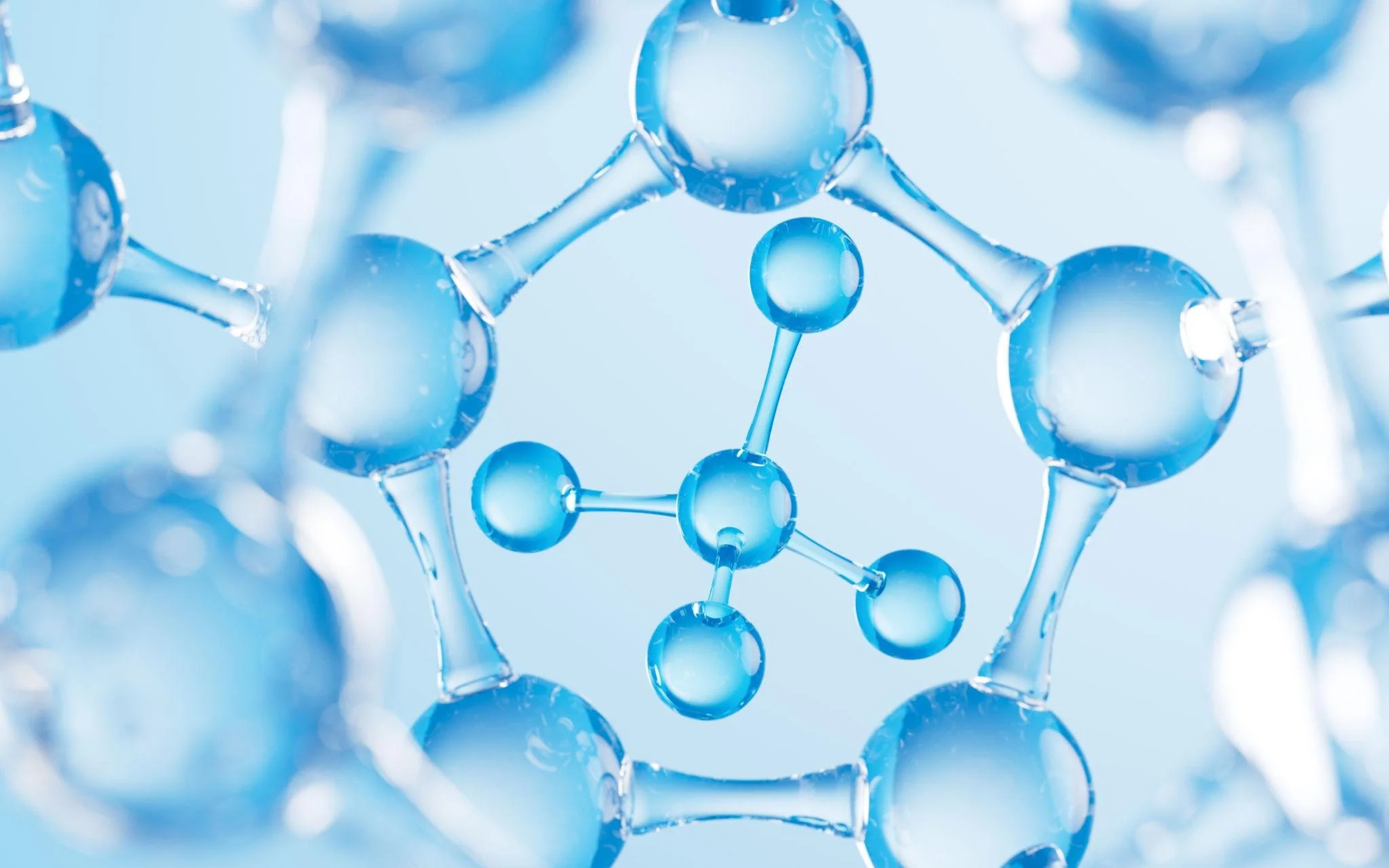 Close-up of a molecule model with blue spherical atoms connected by rods, representing a chemical structure.