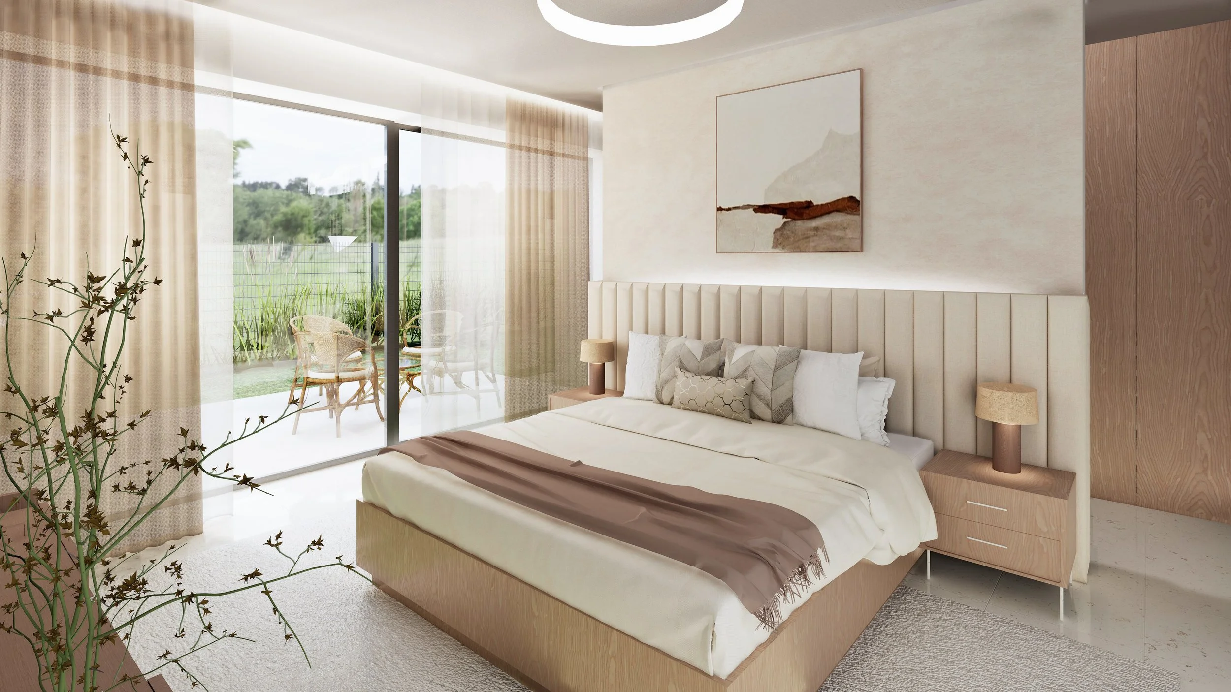Modern bedroom with a large bed, beige headboard, and side tables with lamps. There's a sliding glass door leading to a balcony with outdoor chairs and a view of a green landscape.
