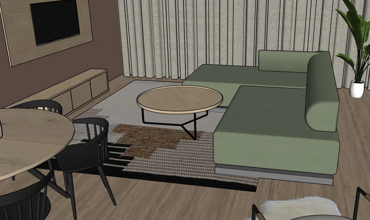 Living room with a green sectional sofa, a round coffee table, a TV on the wall, a sideboard, a dining table with black chairs, a patterned rug, curtains, and a potted plant.