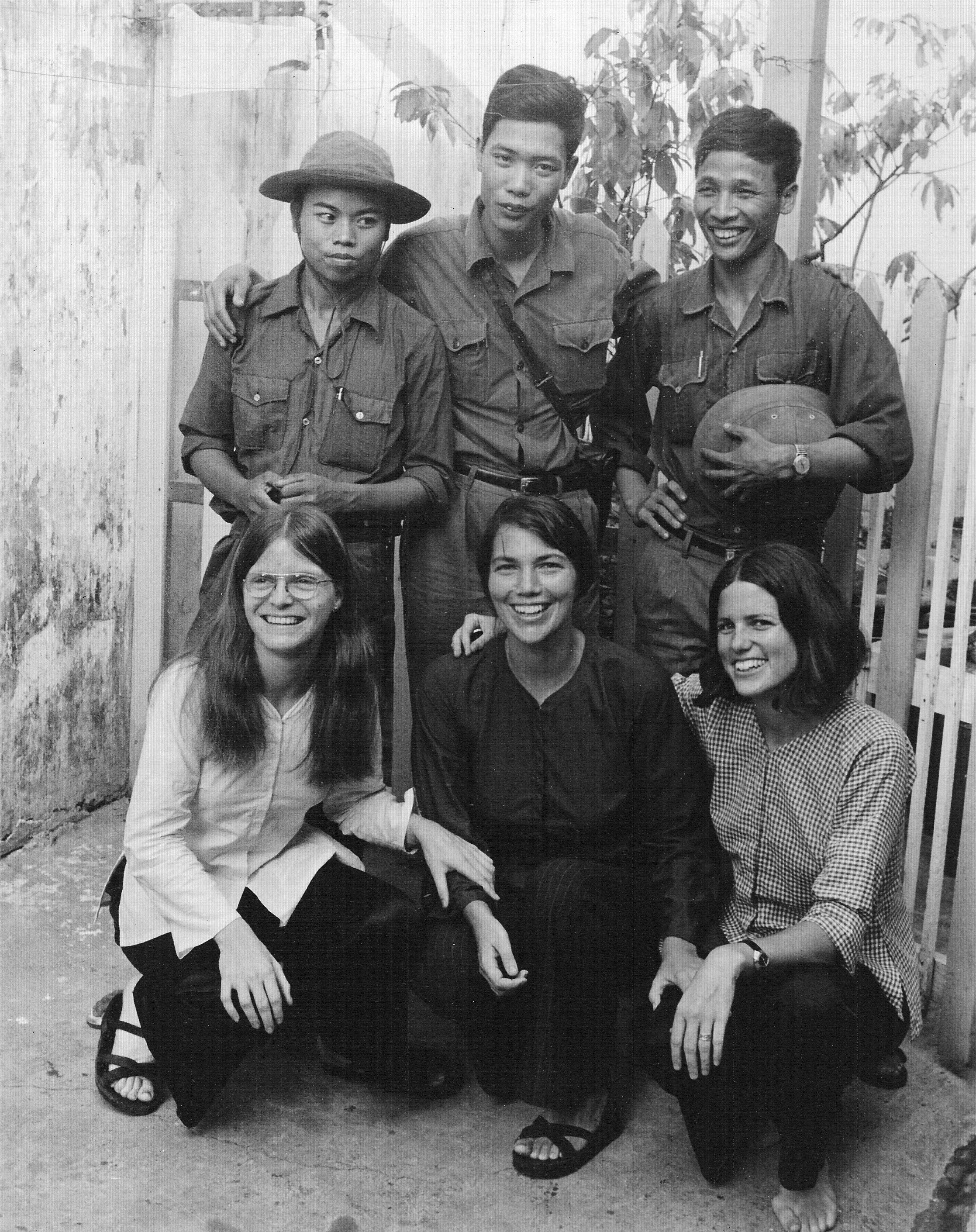 Three North Vietnamese soldiers posing with  three AFSC women in early May, 1975