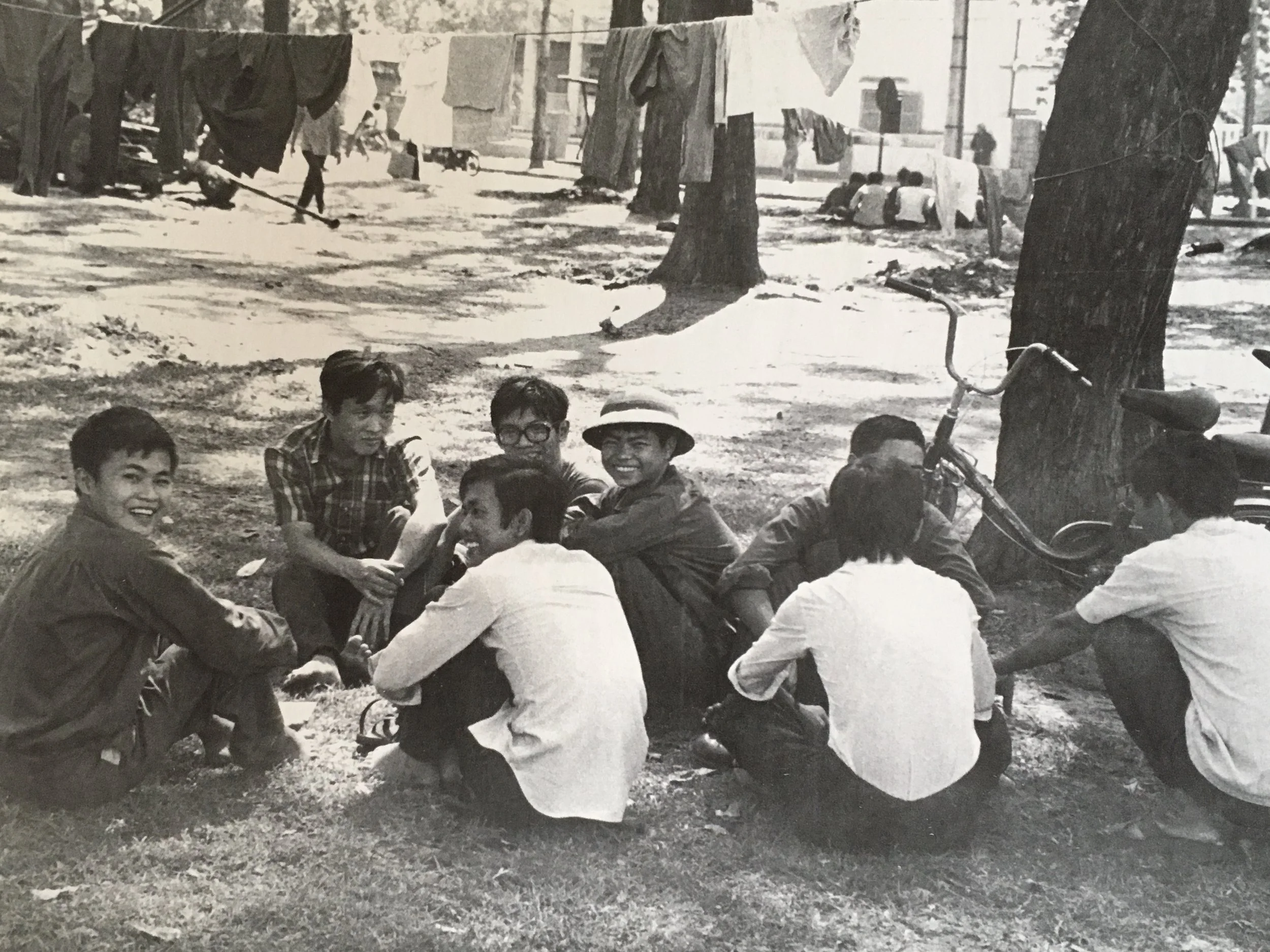 In park in front of Presidential Palace, North Vietnamese soldiers chat with locals.