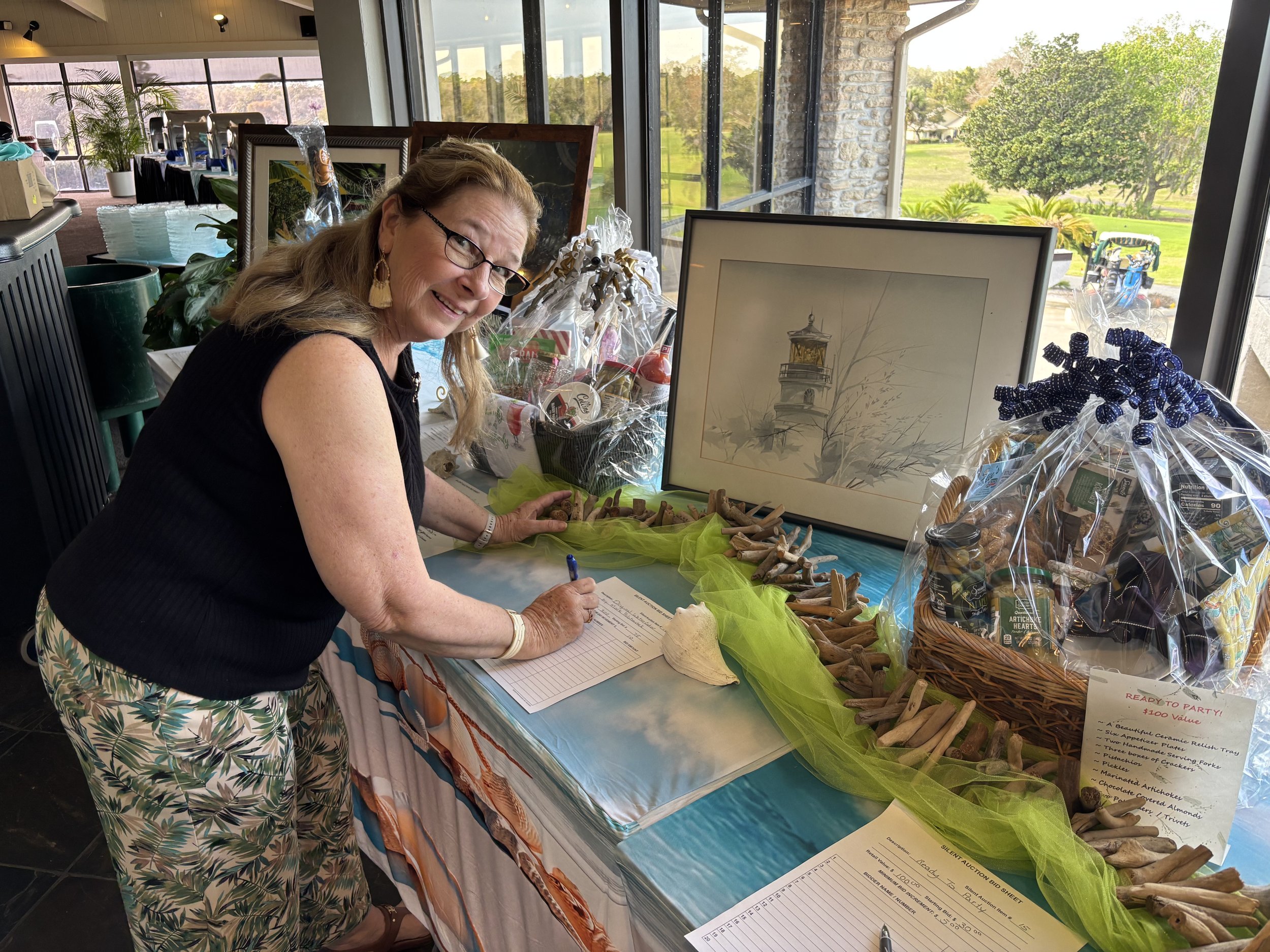 COH Board Member Barbara Stolz sets up the auction items