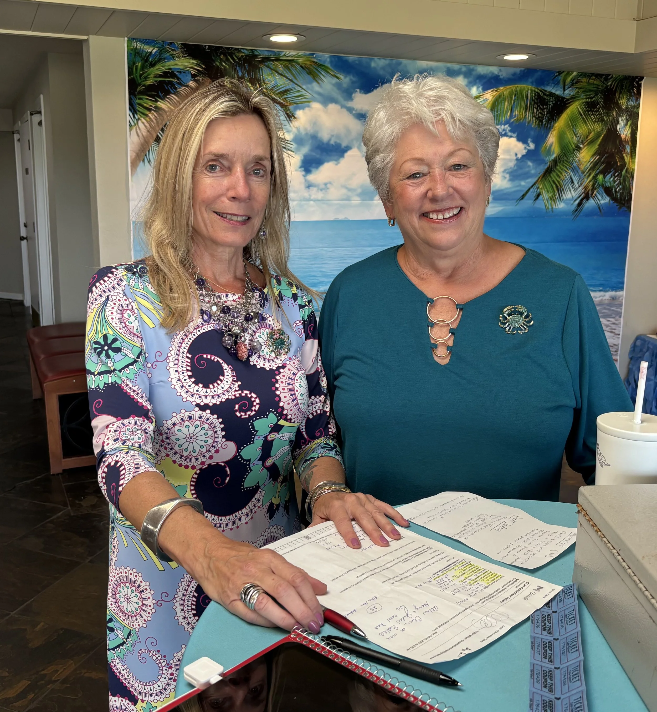 COH Board Members Carol Raskin and Bobbi Wilson greet the guests 