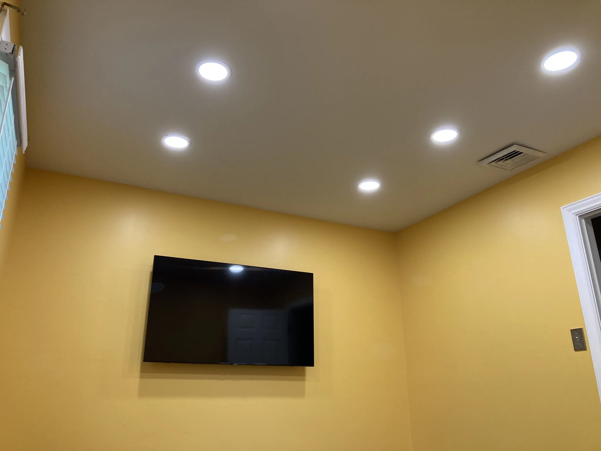 TV hanging, Wire hiding and recessed lights completed by Sinicki Home Improvements. 