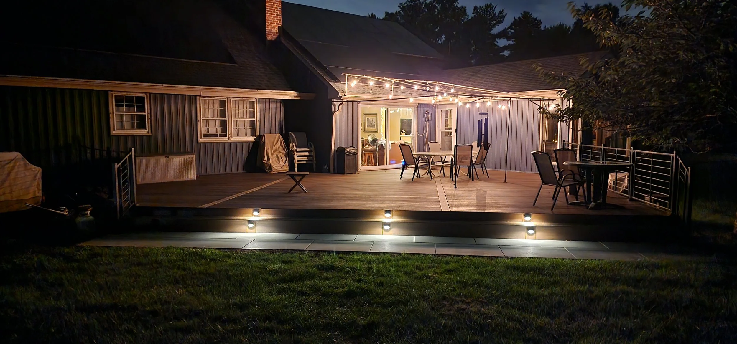 Deck resurfacing and landscape lighting complete by Sinicki Home Improvements.