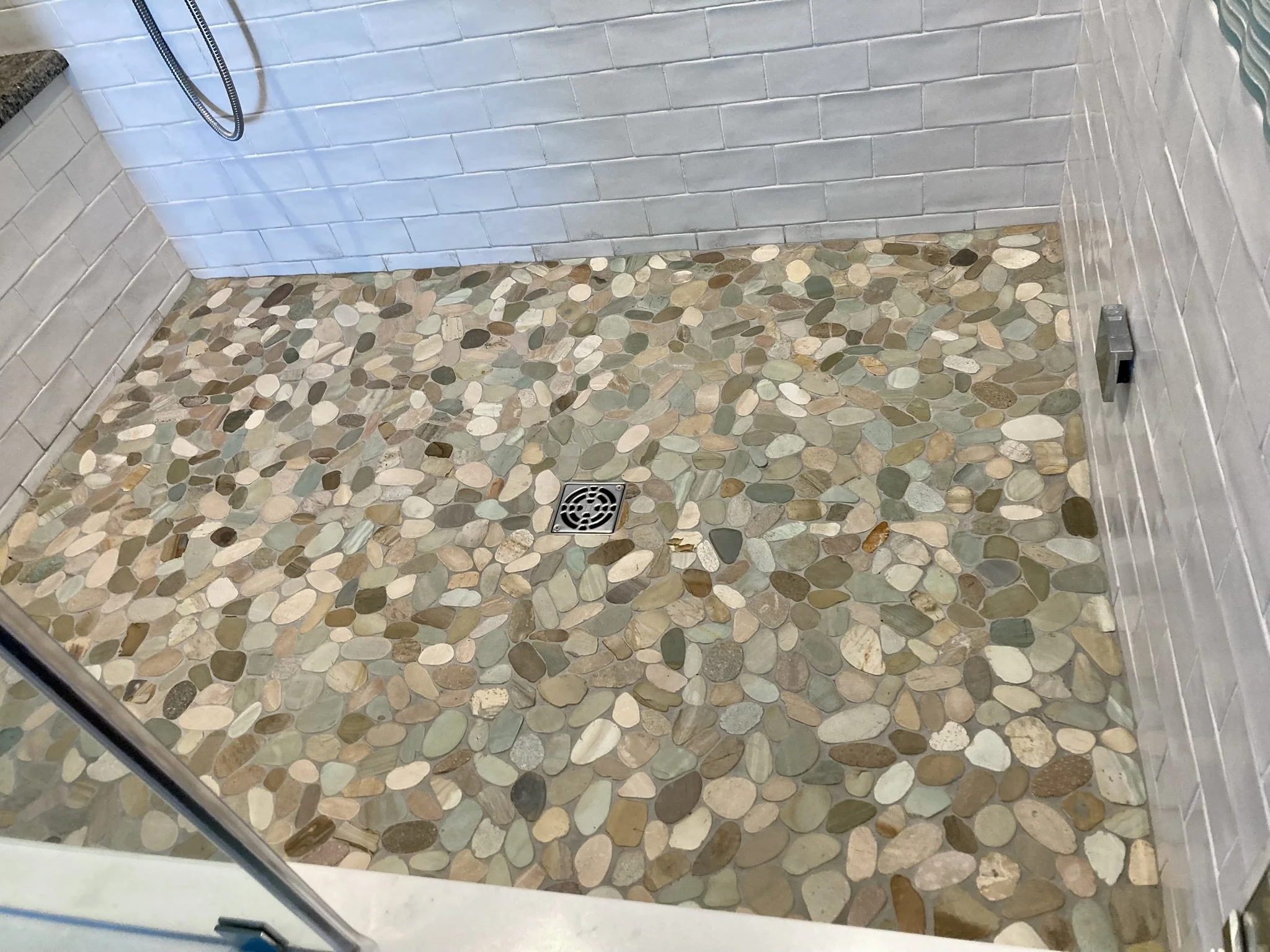 New shower tile floor installed in Toms River, NJ by Sinicki Home Improvements