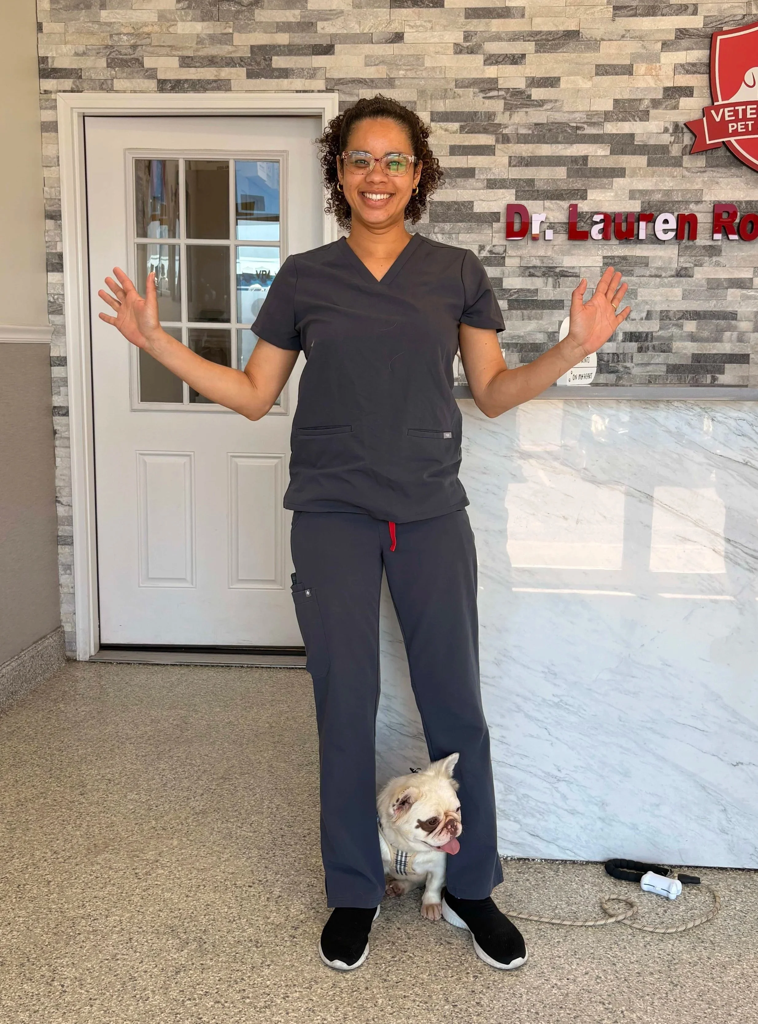 Veterinary team member with pets inside Veterinarian Pet Alliance, supporting surgery consultation care in Newark, NJ.