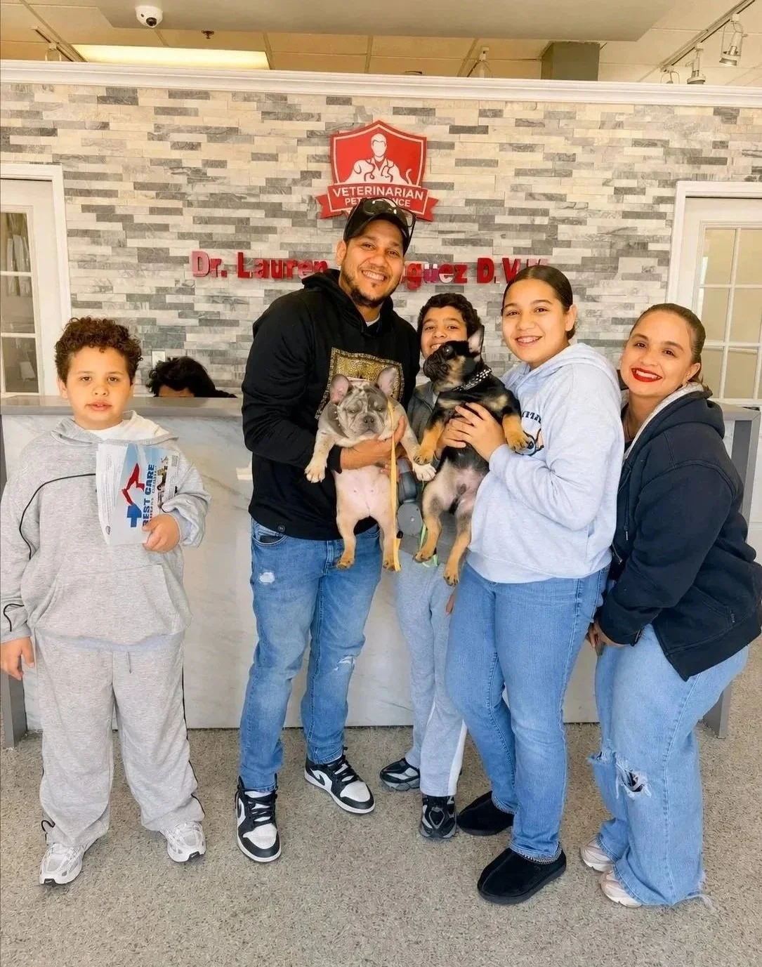 Family with dogs at Veterinarian Pet Alliance for pet travel certificate support in Newark, NJ.
