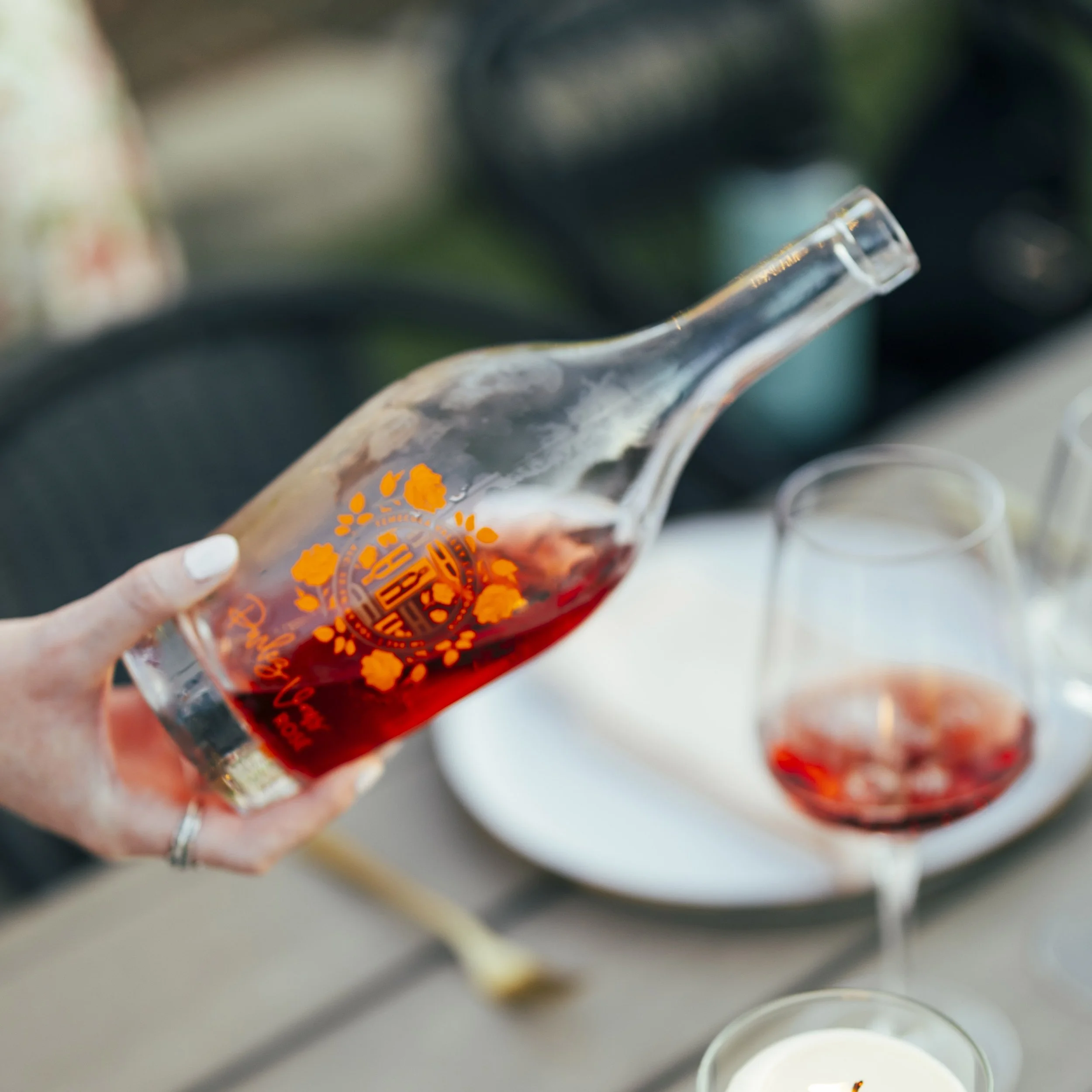 rosé wine bottle being poured at Akash Winery