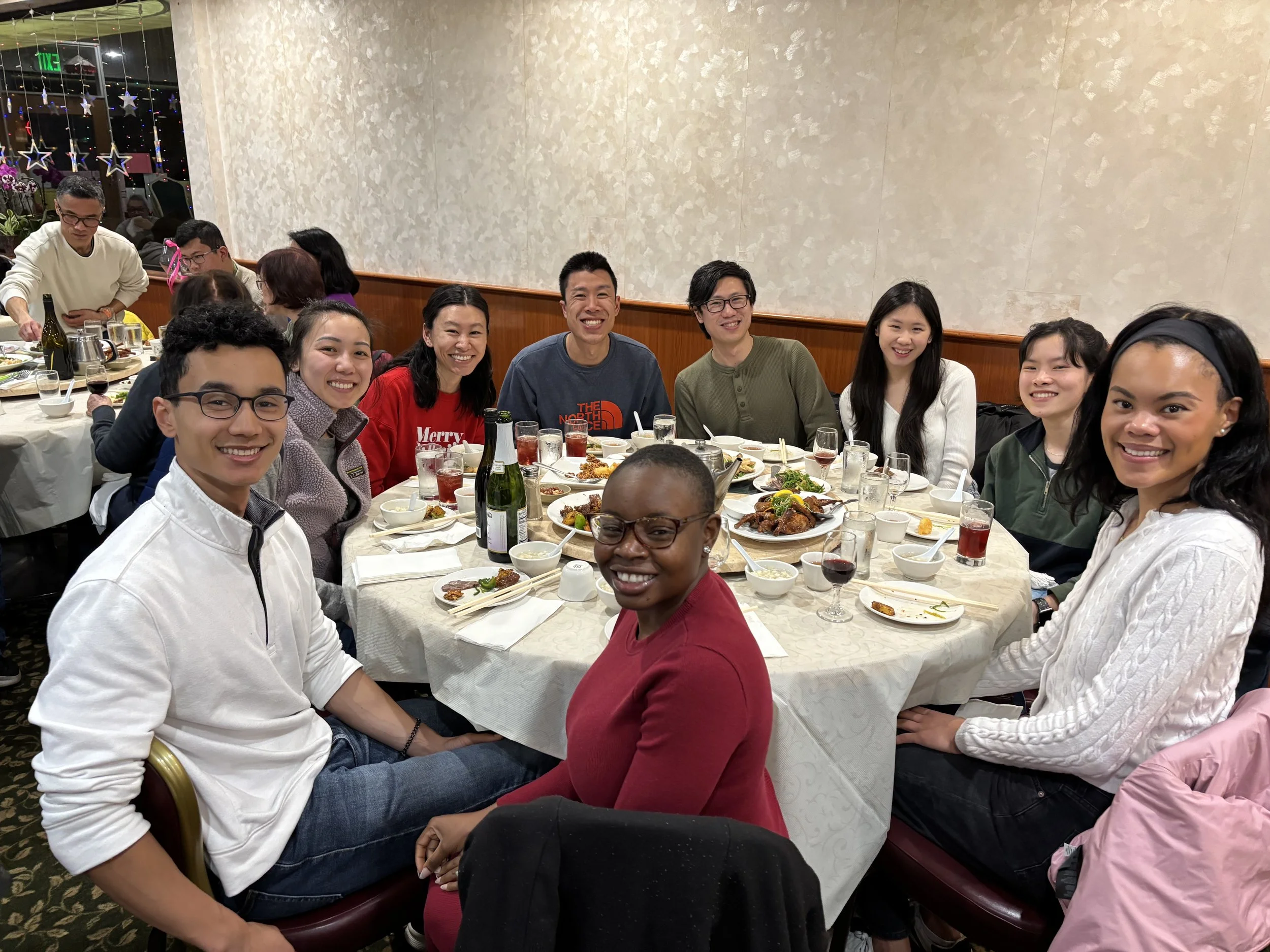 Robert and Mope enjoying a meal at a round table in a restaurant, with Robert's family.