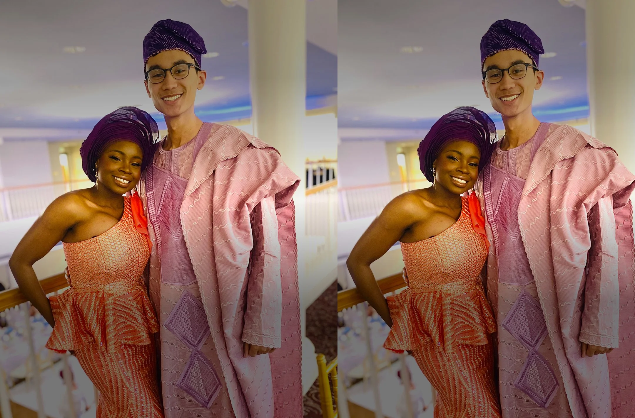 Mope in a coral dress with African patterns and a Robert in a traditional Nigerian attire, both dressed in vibrant cultural clothing, standing indoors with a colorful background.