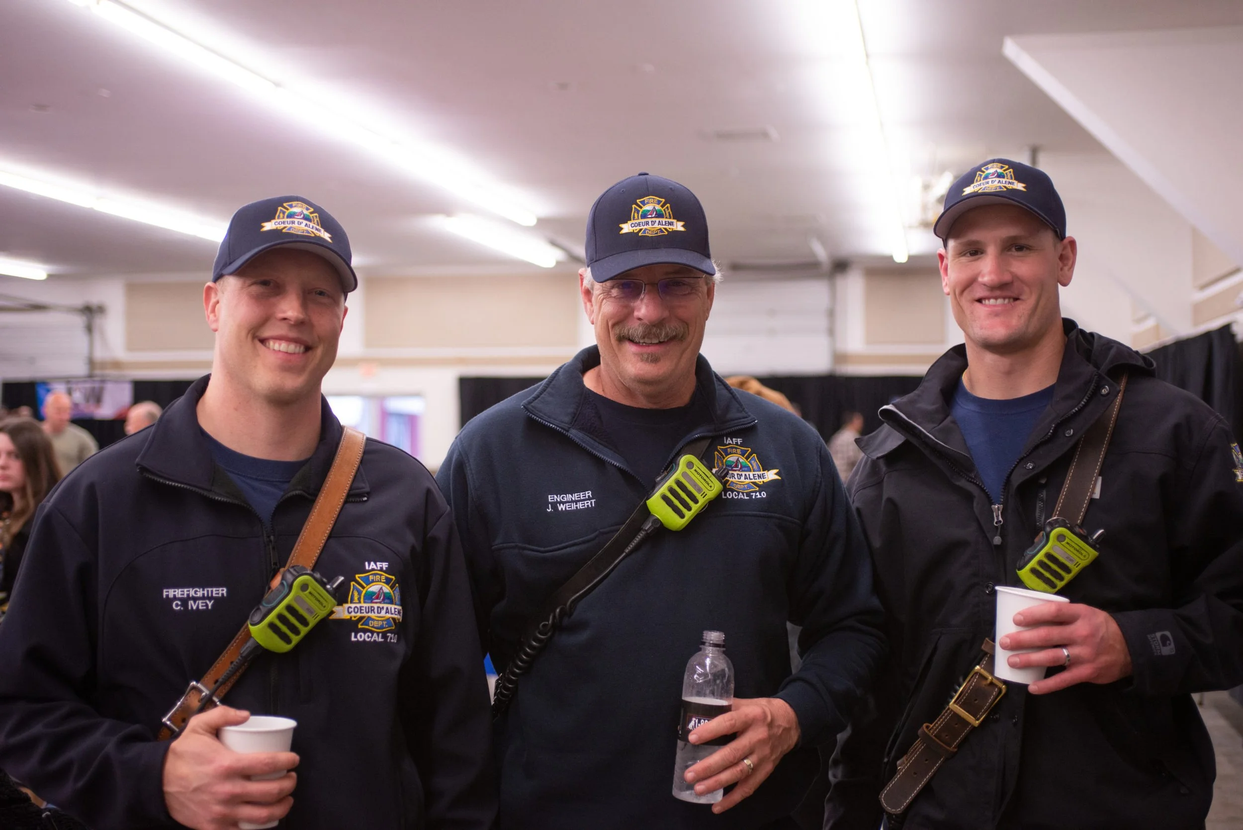 Three firefighters smiling at the camera