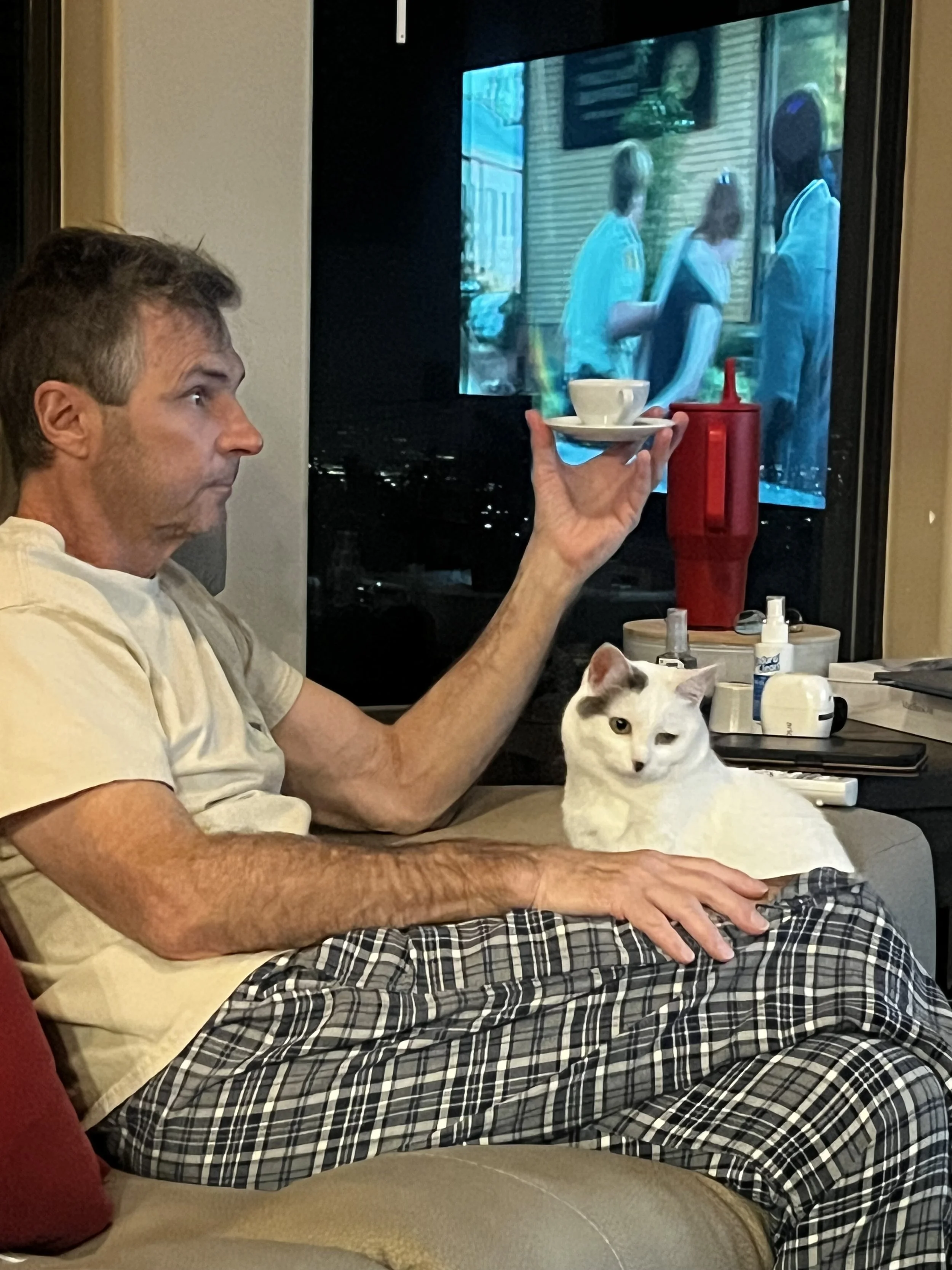 Enjoying his espresso with Nila the kitty