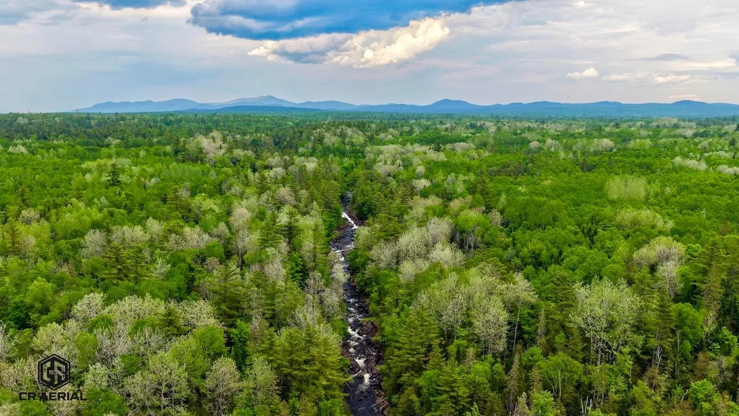 🌲💧 You think this picture is cool? Wait until you see the video of Moxie Falls!

From above, the winding river cuts through an endless sea of Maine forest, with the mountains standing watch in the distance. But this is only part of the story. Moxie