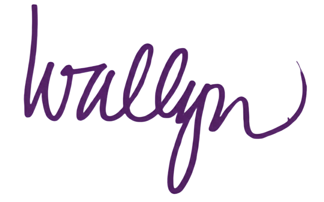 Close-up of the word "wollyph" written in purple cursive script on a white background.
