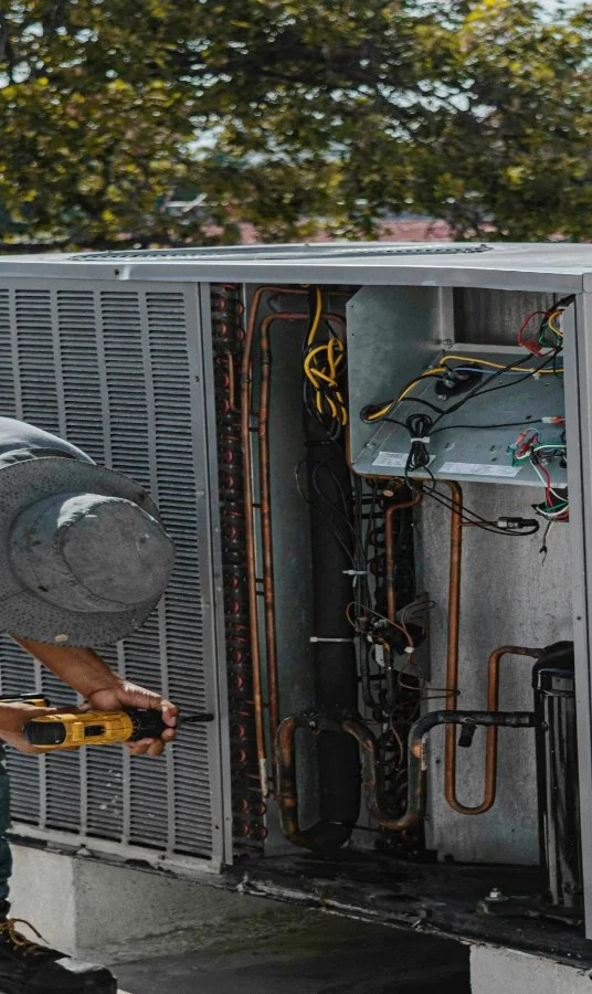 Technitican servicing an air conditioner