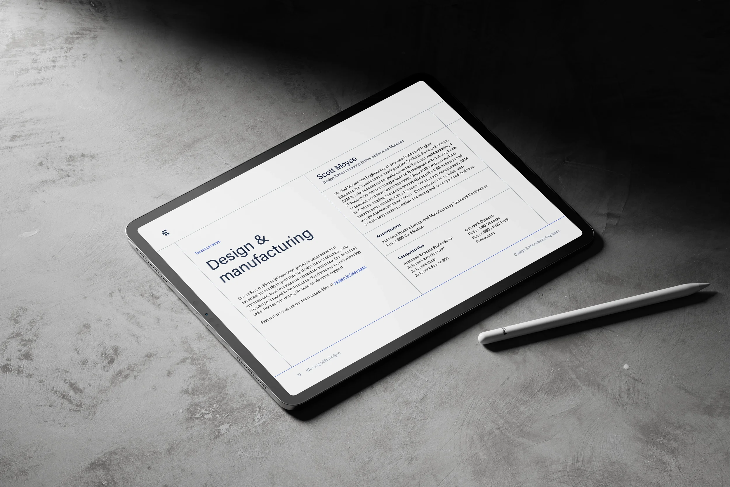 Digital tablet on a gray textured surface displaying a resume or CV document for Scott Moyse, focusing on design and manufacturing experience, courses, and certifications. A white stylus pen rests nearby.