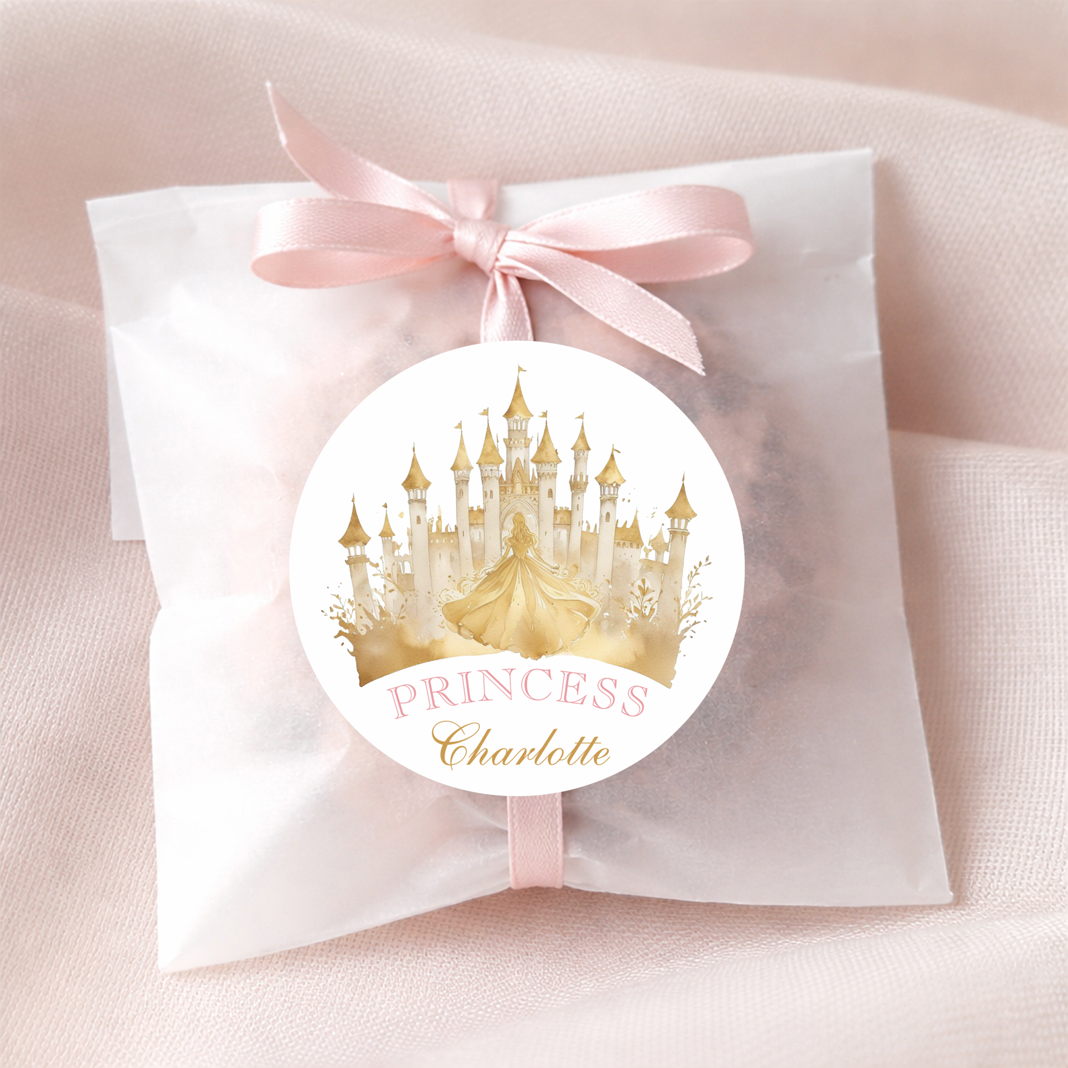 Princess birthday party favor bag with pale pink ribbon and personalized castle sticker in pink and gold princess theme