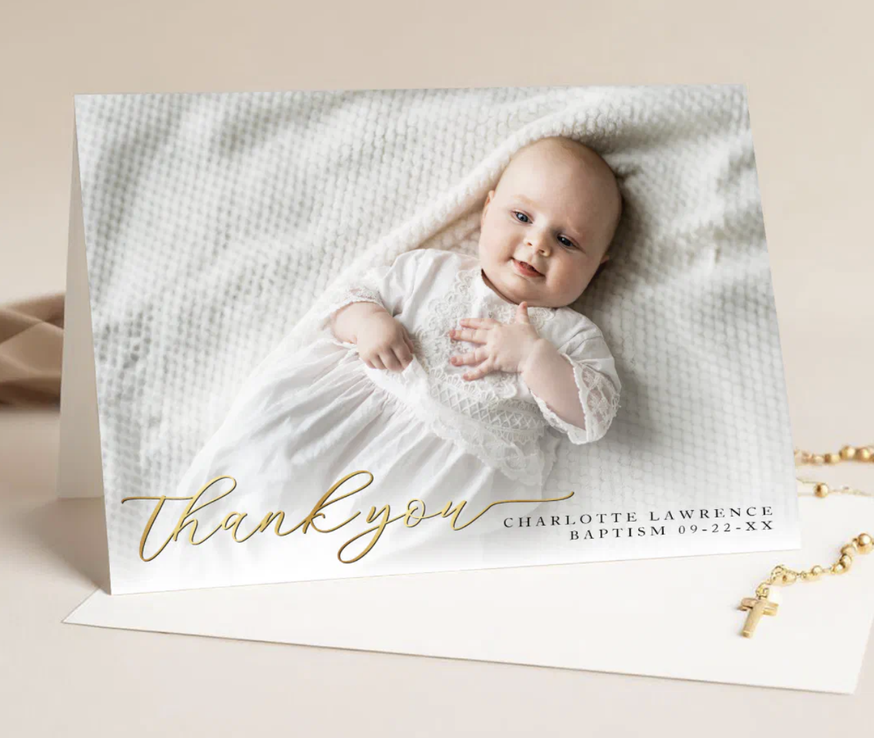Folded baptism thank you card with modern gold script text and space for a personalized message inside.